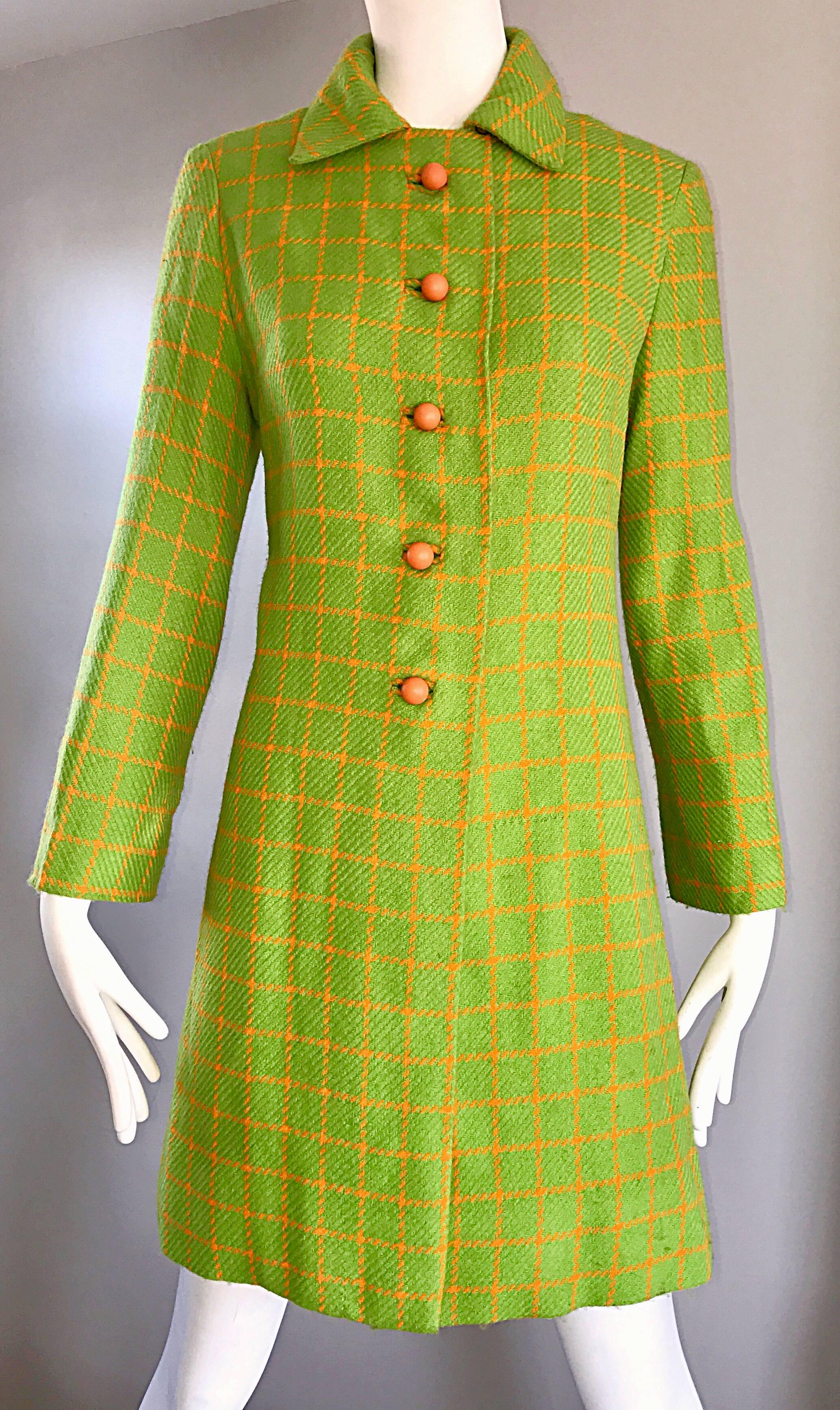 Chic vintage 60s neon lime green and bright orange checkered mod wool swing jacket! Flattering fit, with a tailored bodice and full body. Cute orange ball buttons up the front. Intricate pleating detail on the back. Fully lined in matching bright
