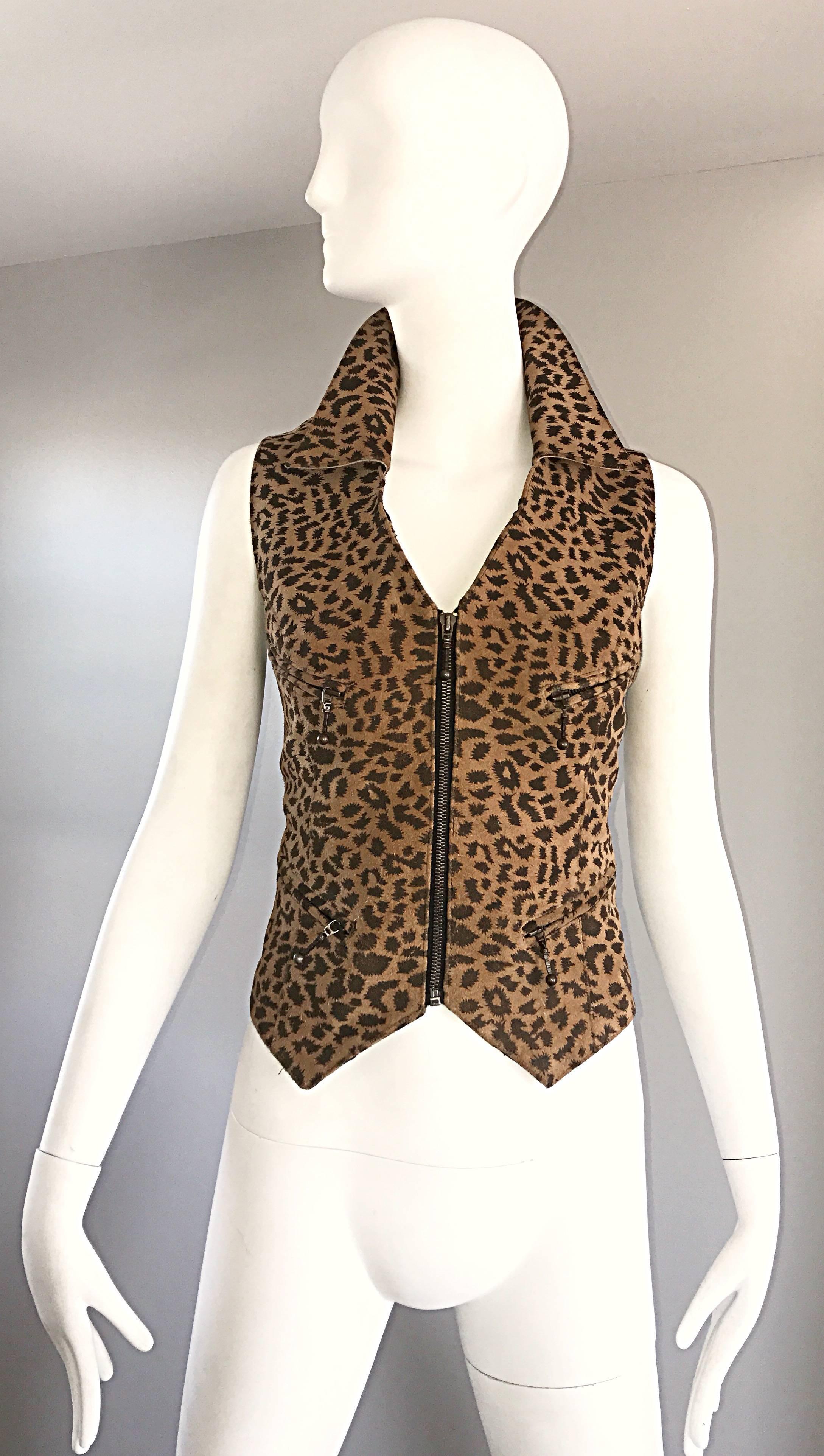 Sexy 1990s leopard print leather / suede vest! Features the classic animal print throughout. Chic collar can be worn flipped up for a little extra sass! Brass metal zipper up the front. Four functional pockets on the front. Adjustable belt in the