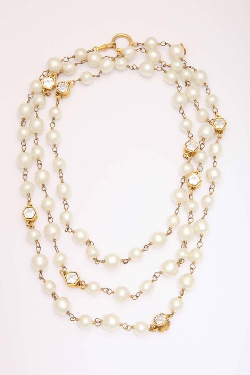 A beautiful classic vintage Chanel necklace with good quality pearls and
crystals set in an interesting gold-plated bezel.   It is long enough to be 
worn doubled or  as a three strand choker .