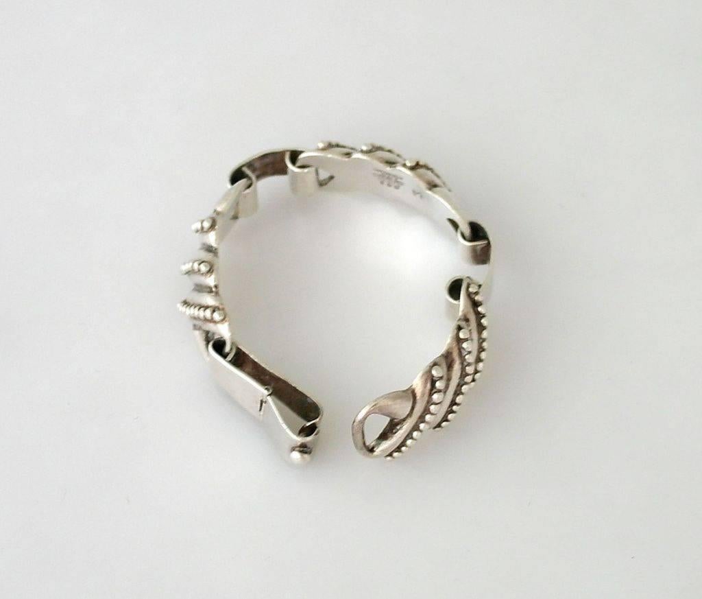 Being offered is a fine circa 1955 sterling silver bracelet by Los Castillo, of Taxco, Mexico; handmade bracelet, curved diagonally wrapped links topped with balls. Dimensions: 7 1/4 inches long x 3/4 inches wide (inner dimensions 7"). Weight: