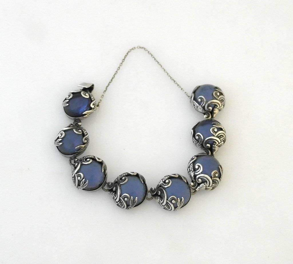 Being offered is a circa 1960 sterling silver and blue glass bracelet by Los Castillo, of Taxco, Mexico, in an art nouveau fish motif.  The construction of each link and setting of stone is remarkable.  Dimensions 6 1/2 inches long.  Marked.  In