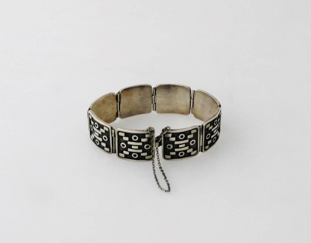 Being offered is a sterling silver bracelet by Pedro Castillo, of Taxco, Mexico, in a modernist design of cutwork and oxidation.  Dimensions: 3/4" wide (inner dimensions 6 3/4"). Weight 2 oz. Marked as illustrated. In excellent