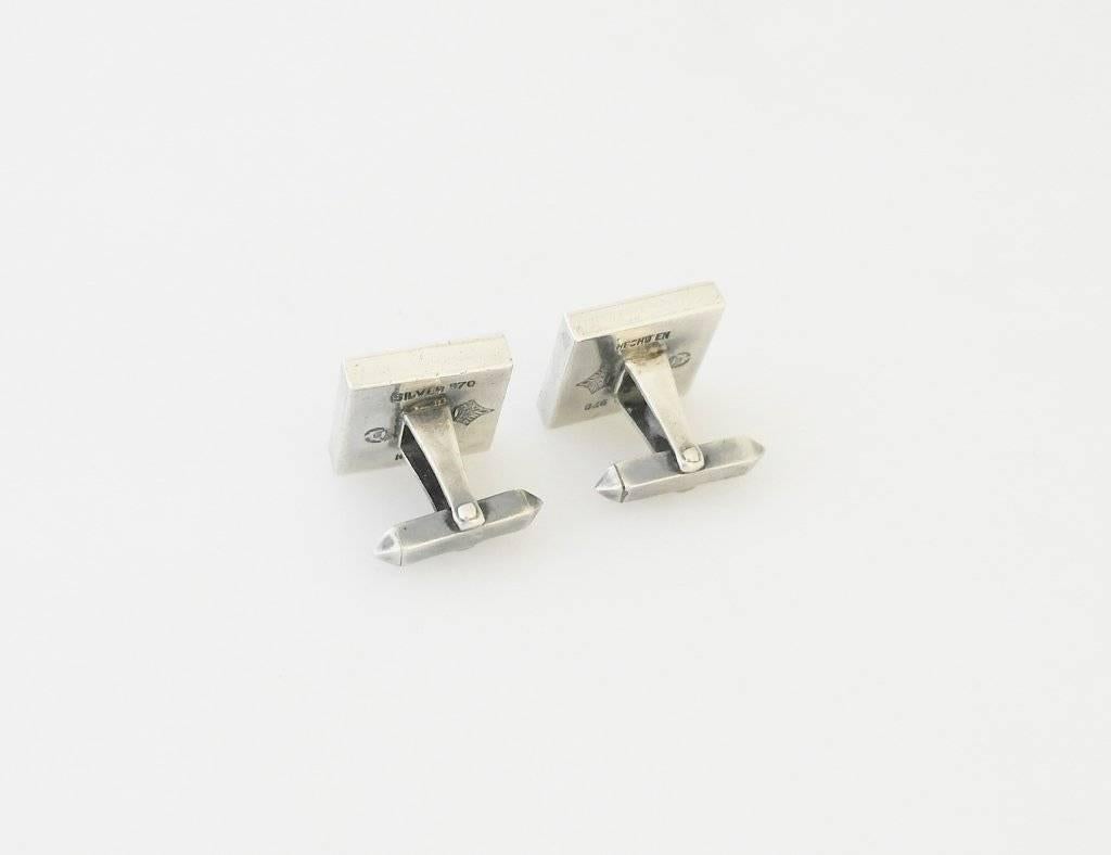 
Being offered are a pair of onyx and .970 silver cufflinks by Antonio Pineda, of Taxco, Mexico, in a straightforward  moderne design.  Dimensions 3/4" by 3/4".  Marked.  In excellent condition.

Stanley Szaro Antonio Pineda Collection
