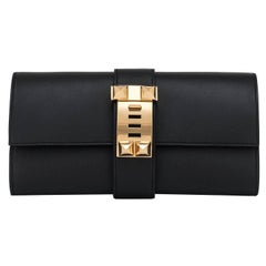 Hermès Black Medor Clutch Swift en cuir doré - Elegant