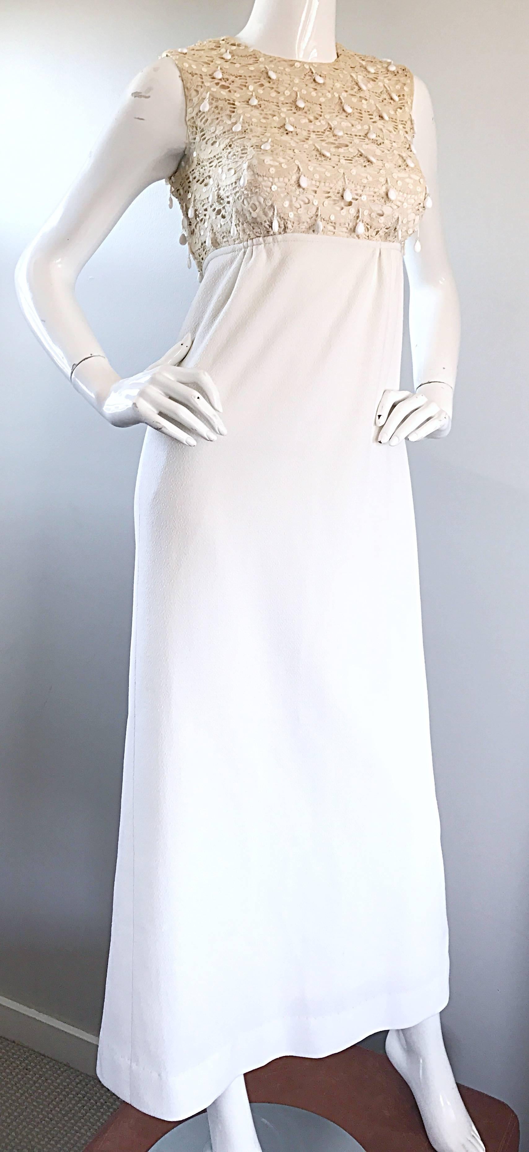 Gorgeous vintage 60s JACKY BRYAN ivory and white full length dress. Features a hand crochet lace bodice, which is adorned with hundreds of dangling white beads on the front and back. Chic full length white skirt. Full metal zipper up th eback with
