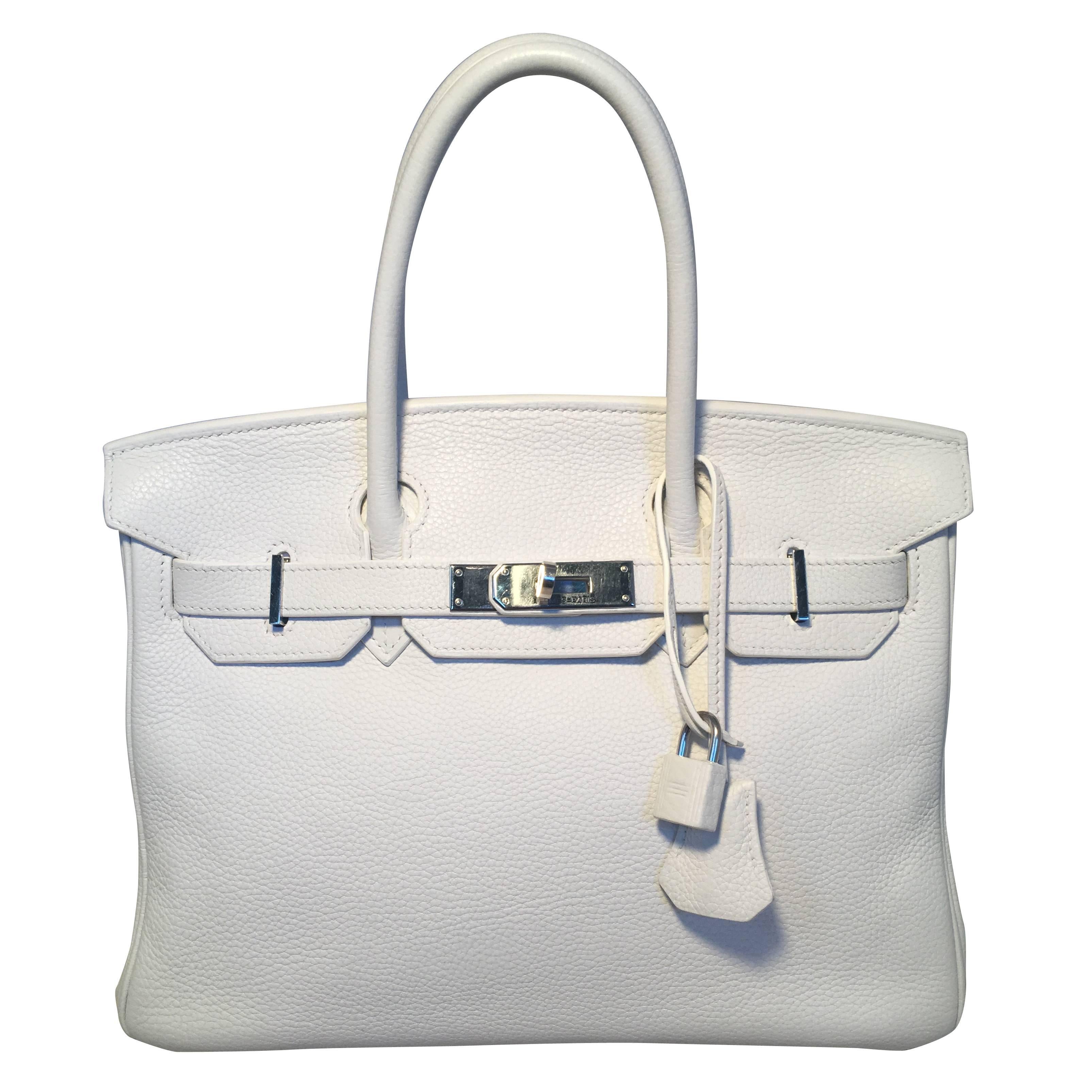 Gorgeous Hermes White Togo leather 30cm Birkin Bag in excellent condition.  White togo leather exterior trimmed with silver palladium hardware.  Front twist double strap closure opens to a white kidskin lined interior that holds the perfect amount