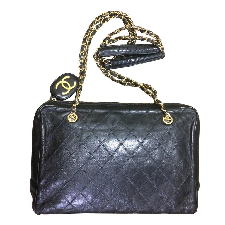 Vintage CHANEL black goatskin shoulder bag with gold tone chains and cc