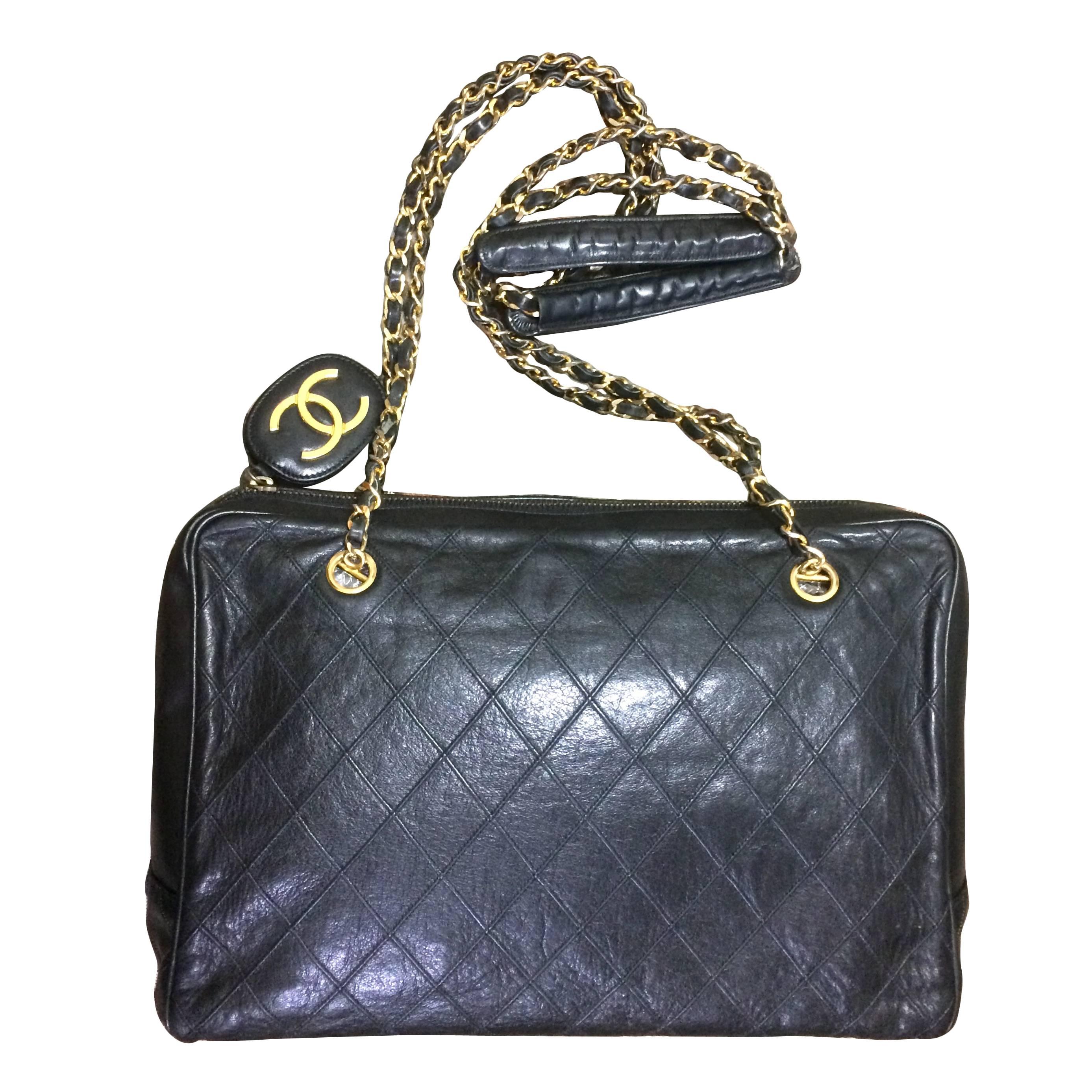 Vintage CHANEL black goatskin shoulder bag with gold tone chains and cc charm. For Sale