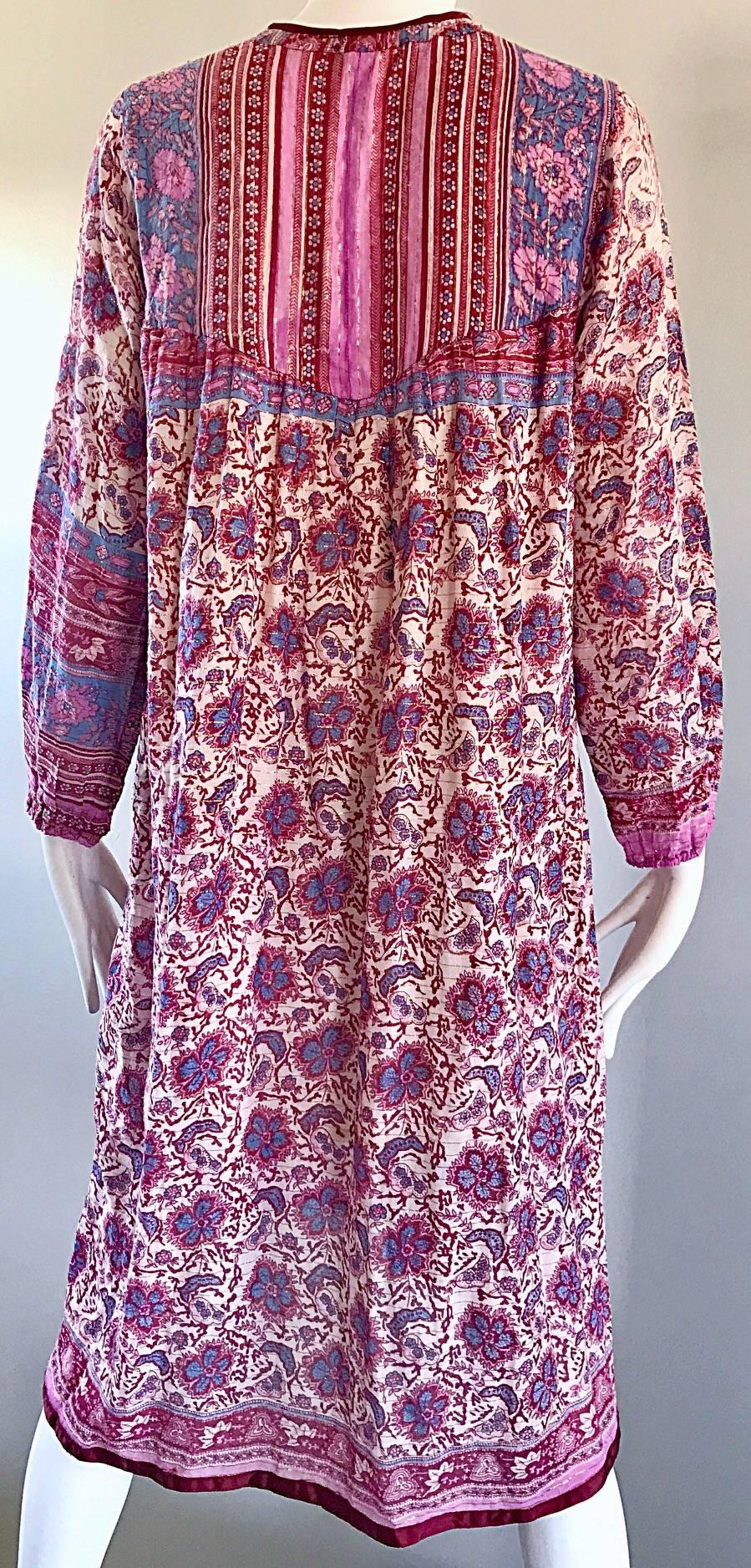 Chic 1970s boho cotton voile ethnic long sleeve sac dress! Features soft colors of pink and purple paisley and flowers throughout. Gold metallic silk thread throughout. Burgundy silk panel above the bust, with addition maroon panels above. Beaded