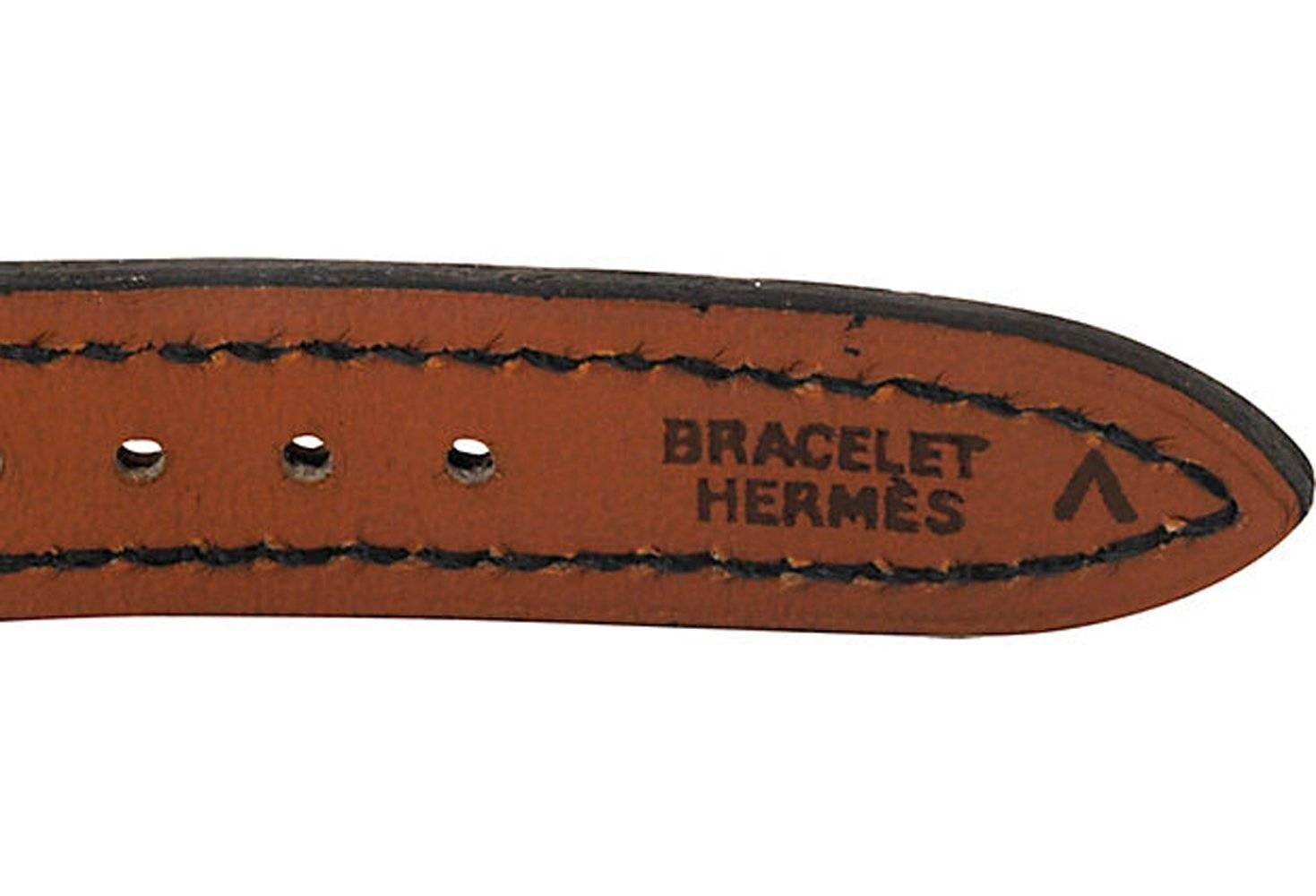 Hermès watchband for the Kelly watch with 18 karat gold plated hardware and navy crocodile band. Stamped: Hermès. 
N.P. Trent has been a respected name in antiques for over 30 years with a large collection of antique and vintage fashion and jewelry. 