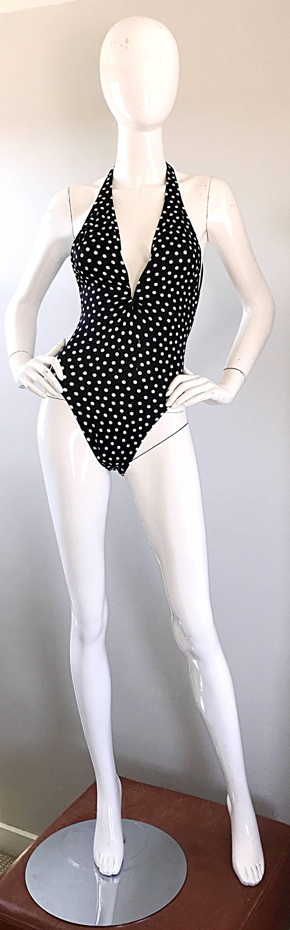 Sexy vintage BILL BLASS black and white polka dot one piece swimsuit or bodysuit! Features a black background with white polka dots throughout. Sexy plunging neckline reveals just the right amount of bust--not trashy at all! Origami detail at back.