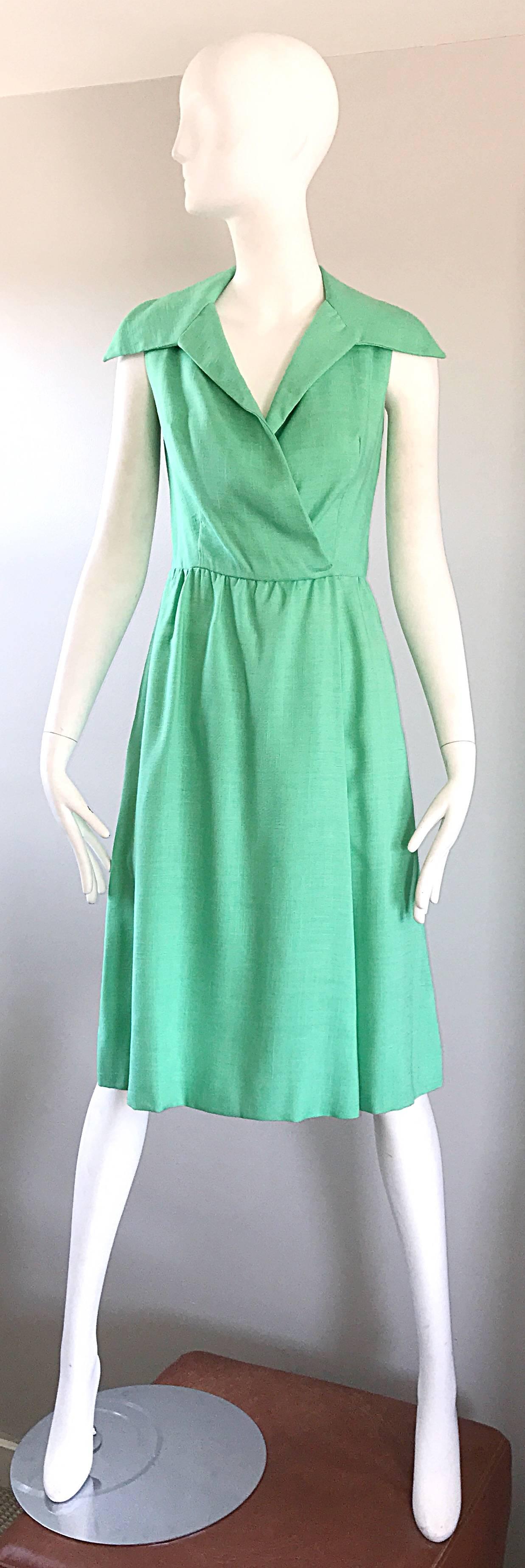 Gorgeous 1950s MOLLIE PARNIS sorbet green linen shirt dress! Chic oversized collar, with a flattering wrap style. Features pockets at each hip. Interior hook-and-eye closures hold everything in place. Looks fantastic on the body, and can easily be