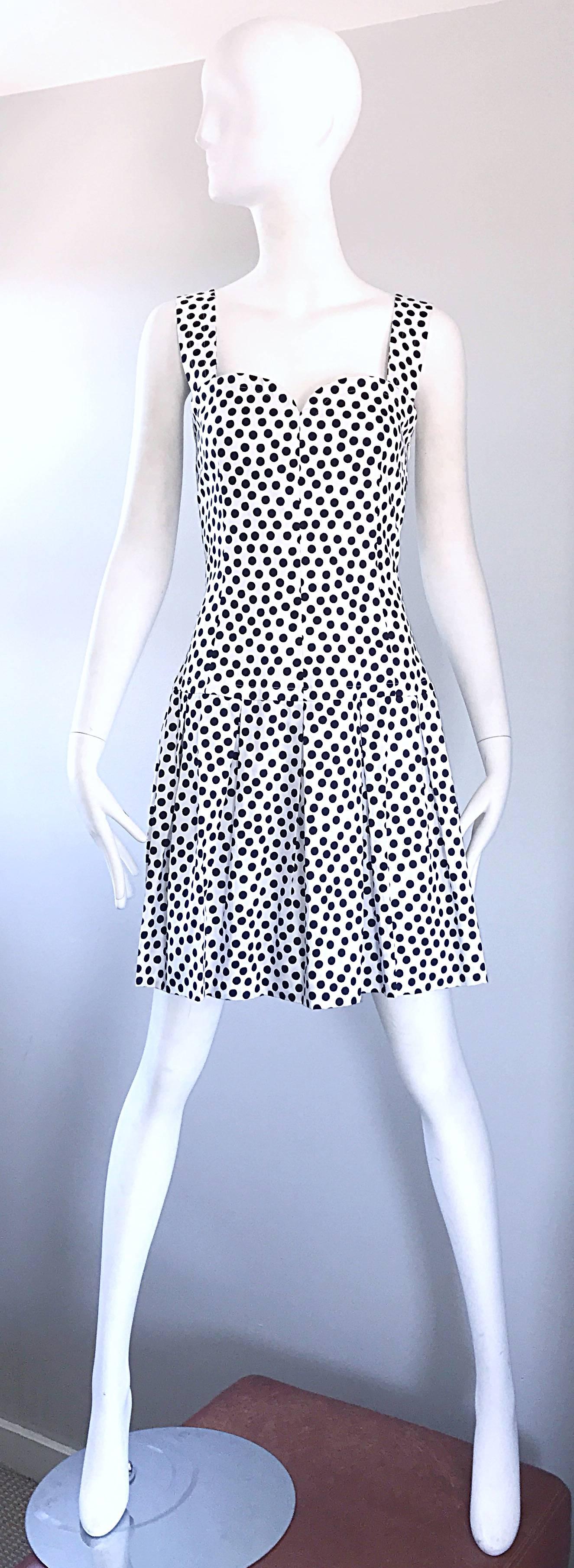 Chic 1990s ALEXANDER MCQUEEN for GIVENCHY COUTURE navy blue and white polka dot cotton dress! Features a fitted bodice, with a ruffled skirt. Hidden zipper up the side with hook-and-eye closure. Extremely well made, with heavy attention to detail.