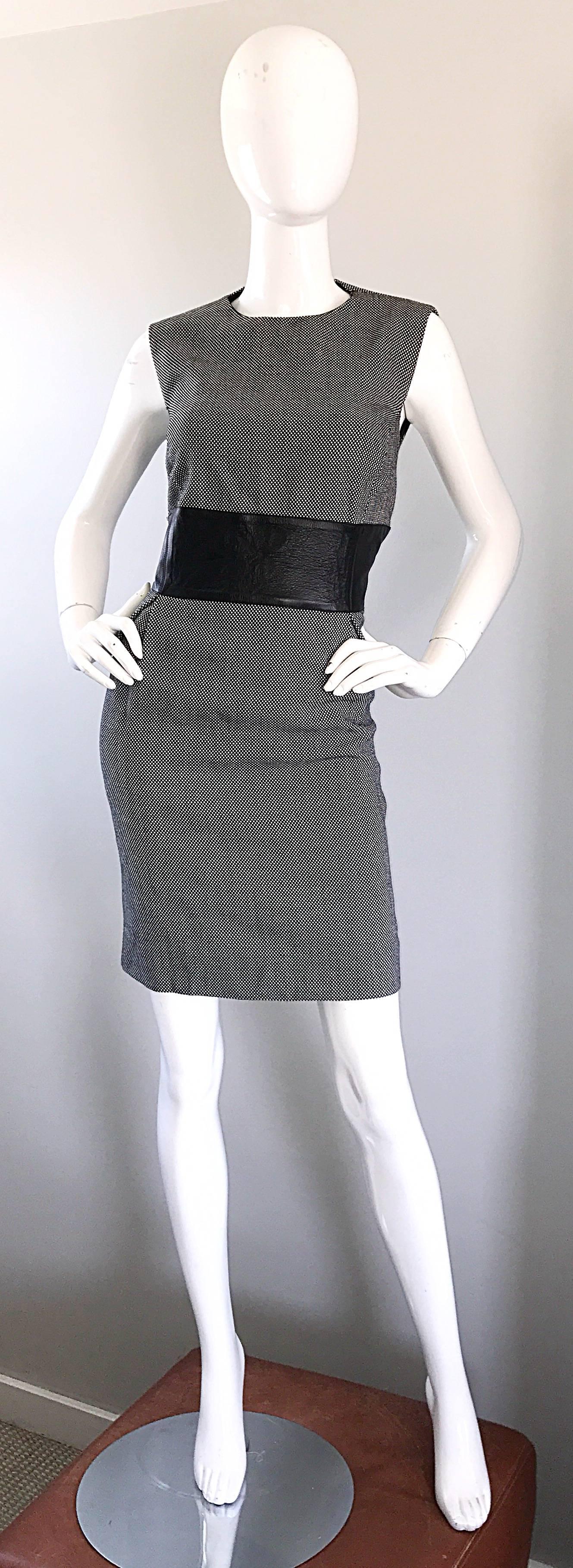Brand new MICHAEL KORS COLLECTION black and white virgin wool and leather dress! Classic style that is very figure flattering. Soft lightweight black and white wool body, with a flattering wide blackl leather band across the front and back waist.