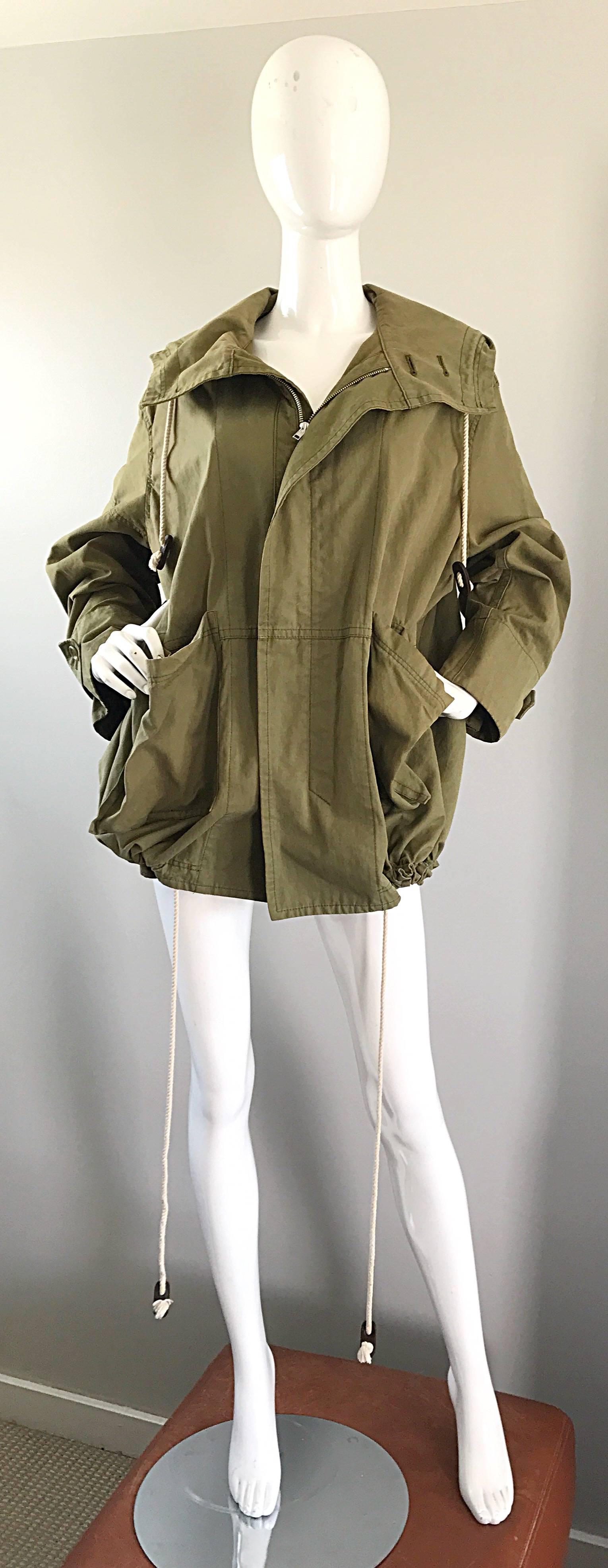 Rare early 1990s Y's by YOHJI YAMAMOTO unisex army creek hooded cargo jacket! Heavy duty cotton, with signature Yamamoto style. Cargo pockets at each side of the waist. Interior drawstrings give permission to fit an array of sizes. Drawstring also