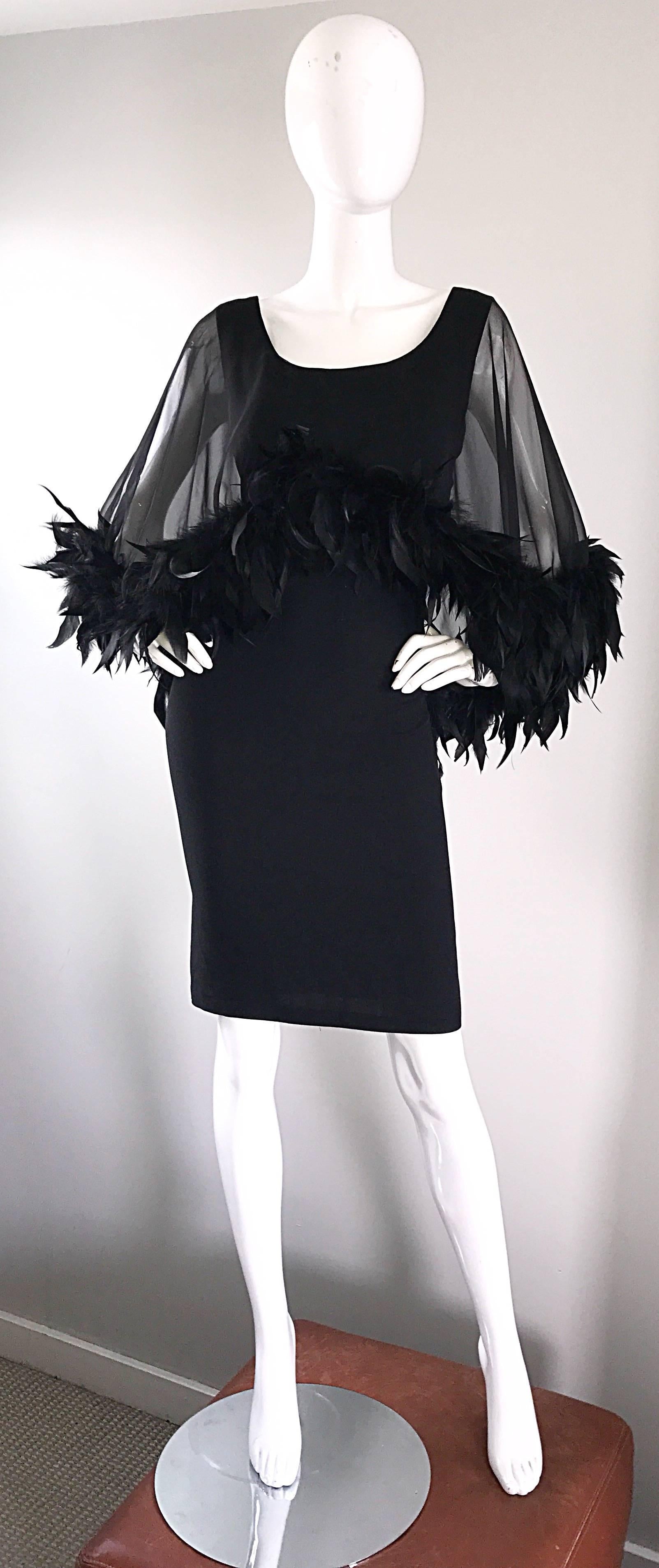 Insanely gorgeous 1950s demi couture black dress, with an attached feather trimmed sheer chiffon overlay. Wonderful flattering form fitting fit looks incredible on the body! So much h attention to detail, with the majority of the craftsmanship