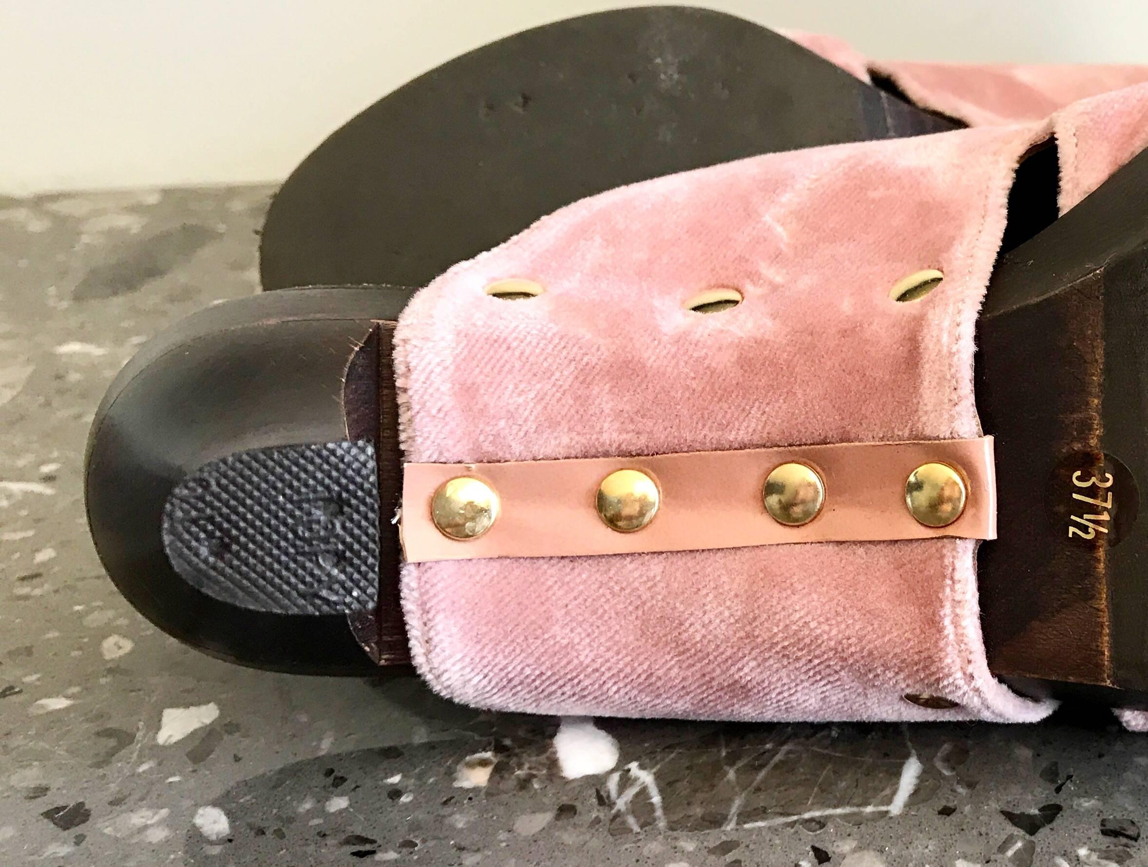 Incredible and rare 90s CHANEL, by KARL LAGERFELD pink velvet high heeled clogs! Features soft pink velvet, with gold brass studs. Slip on style is both chic and easy to wear. Super comfortable at just the right height with a slanted wooden heel.