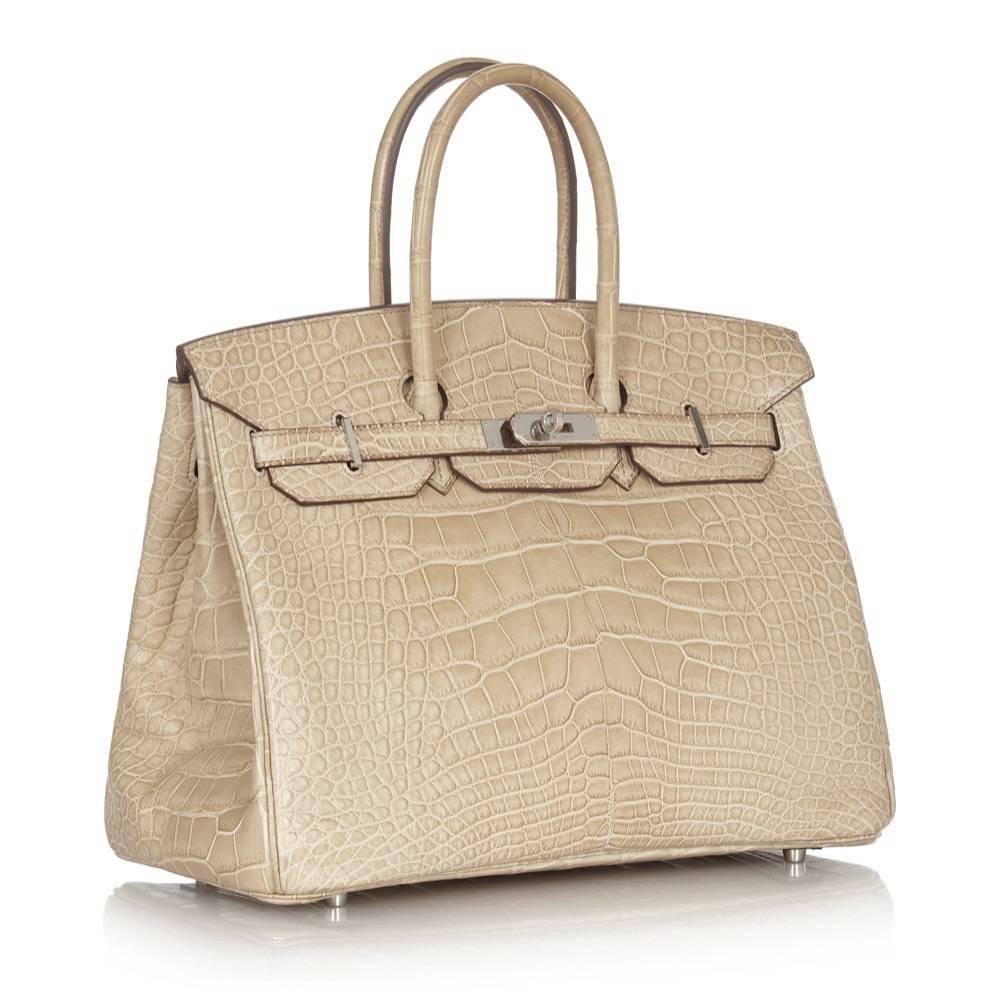 Crafted in matte Poussiere beige Porosus alligator leather and offset by cool-toned palladium hardware, this Hermès Birkin is a strikingly elegant statement piece. Porosus alligator is often lauded as the most precious of Hermès' exotic skins,