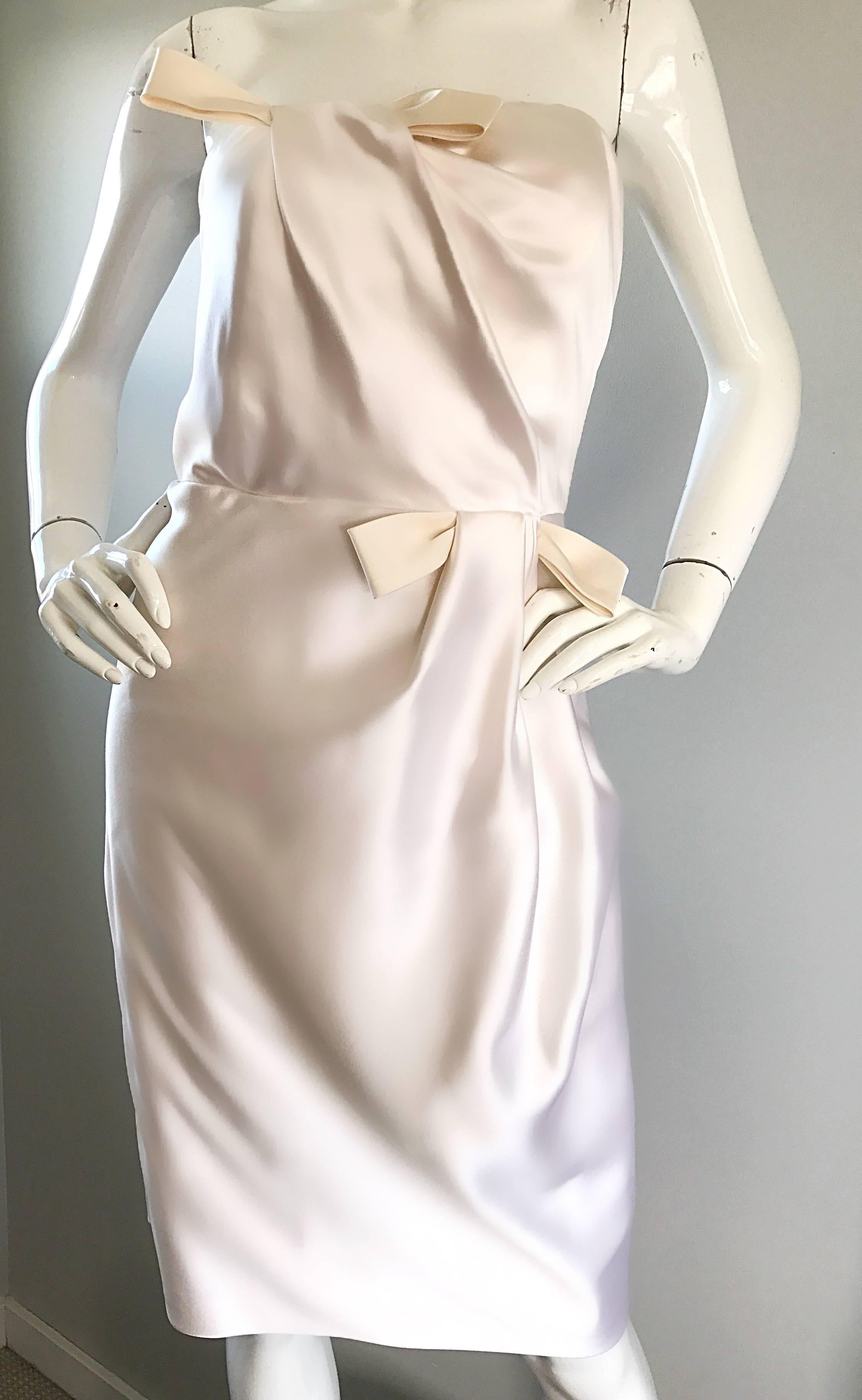 Gorgeous 90s BILL BLASS ivory white strapless silk satin cocktail dress! Features a flattering draped bodice, with an attached bow at right bust and left waist. Interior bodice boned support to keep everything in place. Hidden zipper up the side