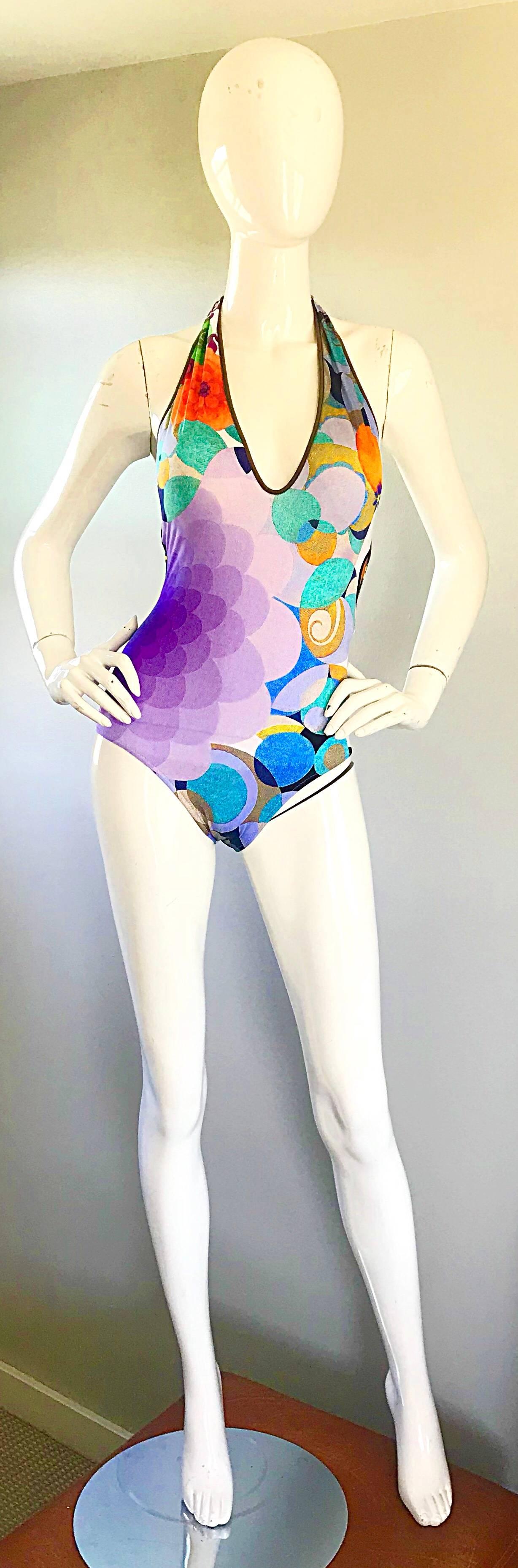 Gorgeous flattering brand new with original tags vintage 90s LA PERLA op-art one piece halter swimsuit or bodysuit ! Features vibrant colors of purple, blue, orange, teal, yellow, and white throughout. Halter neck loops through a white plastic