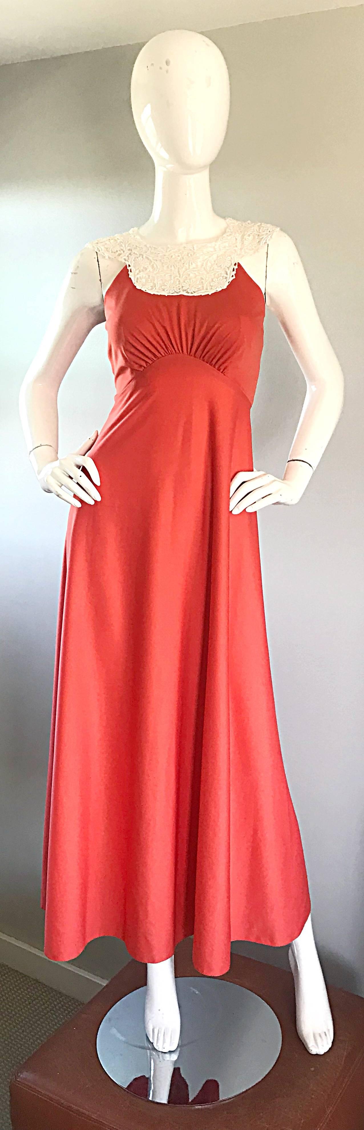 Striking coral / salmon pink jersey maxi dress! Hard to find color that compliments nearly any skin tone! Slinky jersey looks fantastic when on. White crochet lace collar makes for a stark contrast. Hidden zipper up the back with hook-and-eye