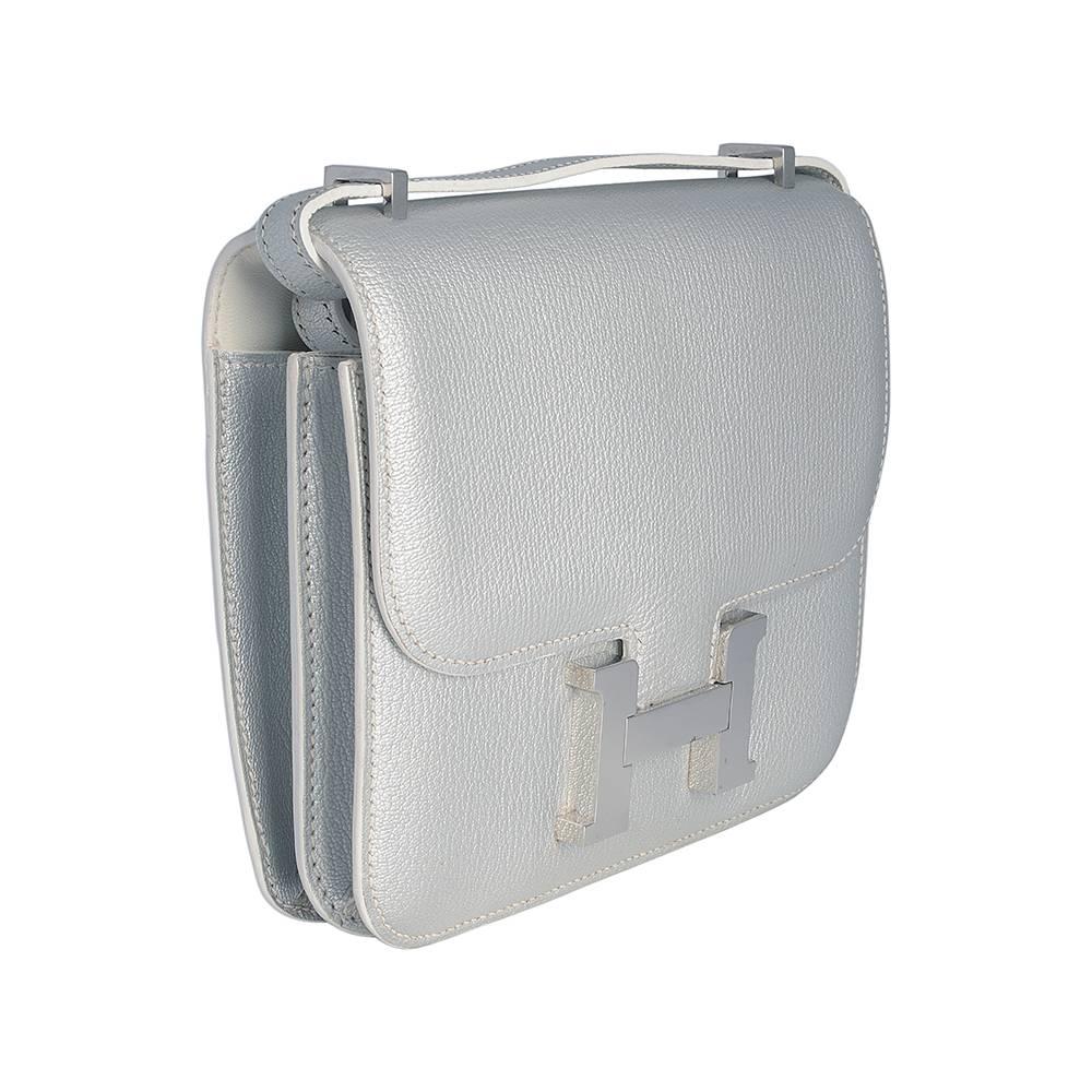 This sleek and minimalist Hermès Mini Constance is crafted in Chevre leather in an elegant silver colour. A highly popular textile, the soft Chevre leather possesses a fine texture that creates a luminous sheen beneath sunlight. This leather is also