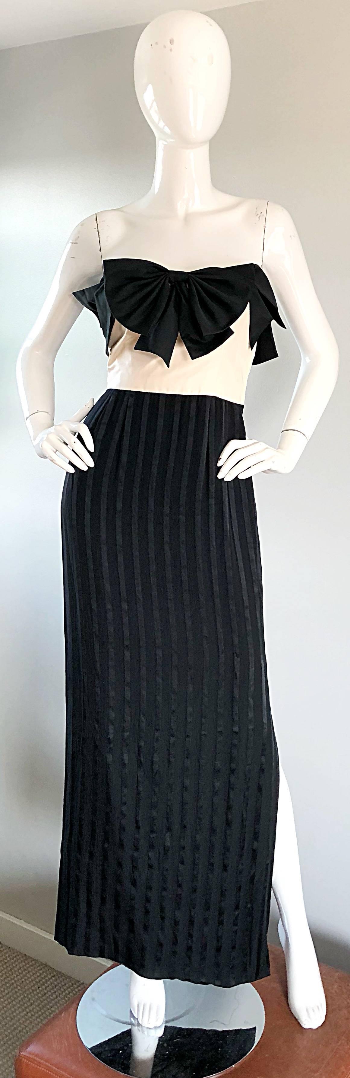 Stunning vintage JEAN LOUIS COUTURE black and white strapless silk evening gown! Features black bows along the front and back top bodice. Ivory silk taffeta bodice, with a black silk skirt. Slit up the left leg reveals just the right amount of skin.
