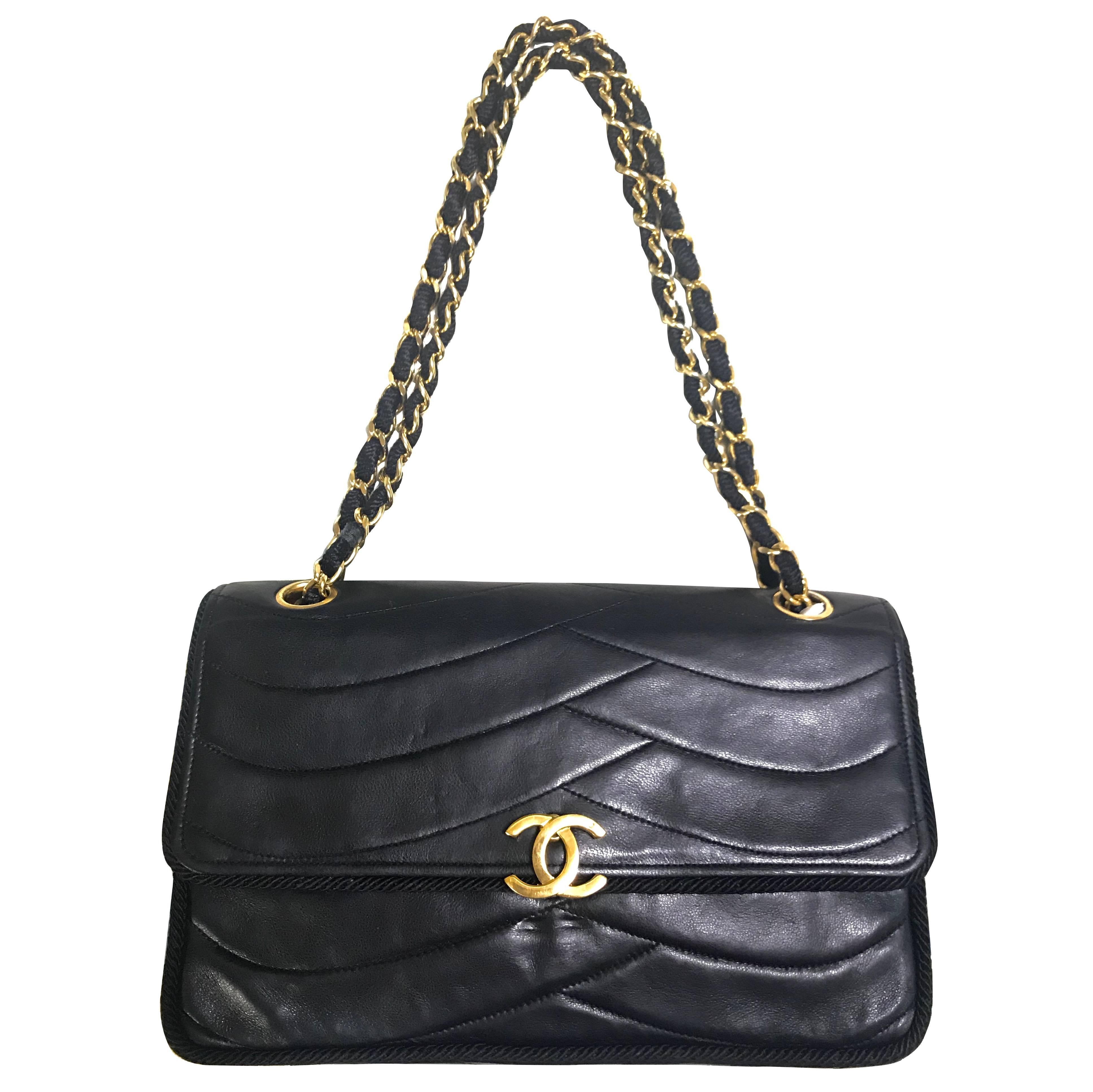 Chanel Vintage black  shoulder bag with wavy stitches and rope strings.  For Sale at 1stDibs