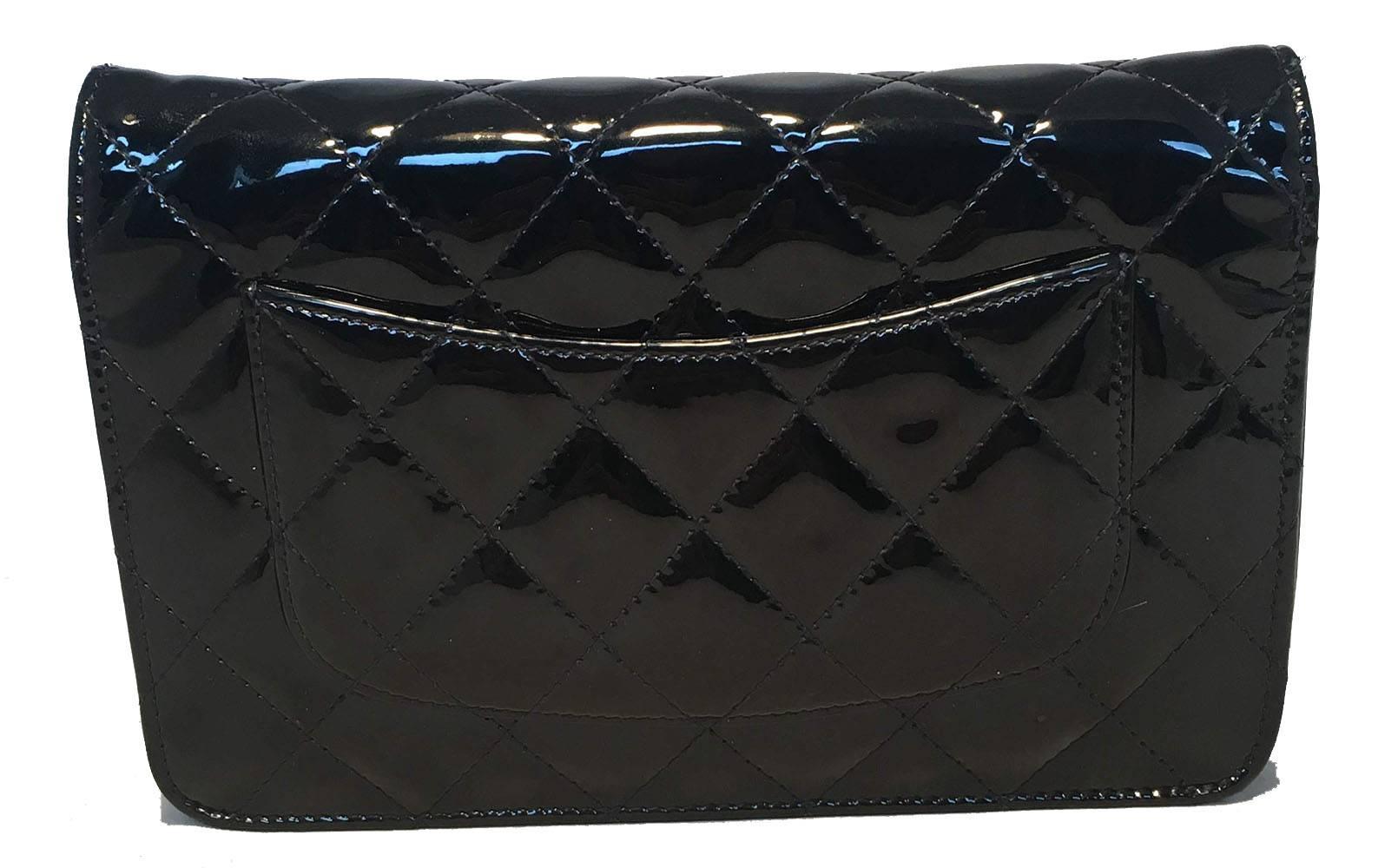Fabulous Chanel Black Patent Quilted WOC Wallet on a Chain Shoulder Bag in excellent condition.  Black quilted patent leather exterior trimmed with silver hardware and signature woven chain and leather shoulder strap. Snap single flap closure opens