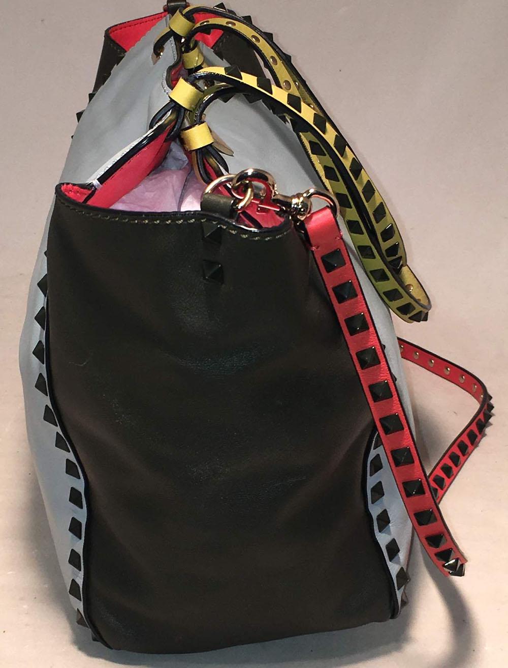 Valentino Garavani Studded Multicolor Leather Rockstud Tote Bag in excellent condition. Multicolor leather exterior with gold hardware and gunmetal studs along edges and shoulder strap. Red, baby blue, dark green, and yellow leather on exterior. Top