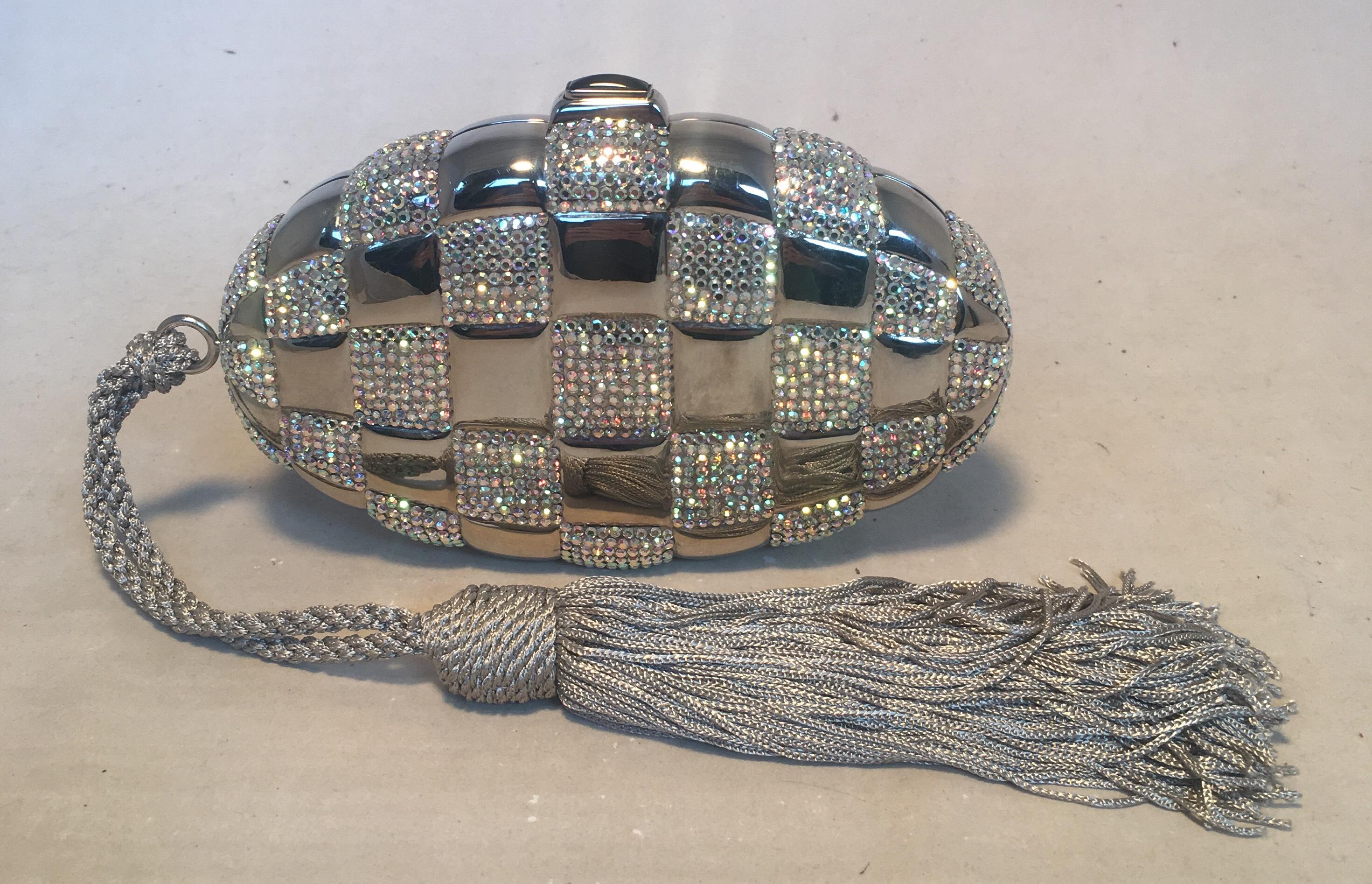 FABULOUS Judith Leiber Swarovski Crystal Checkered Grenade Minaudiere Evening Bag in excellent condition. Silver exterior body with iredecent Swarovski crystals in a checkered pattern throughout. Corded grey nylon rope tasseled handle to wear around
