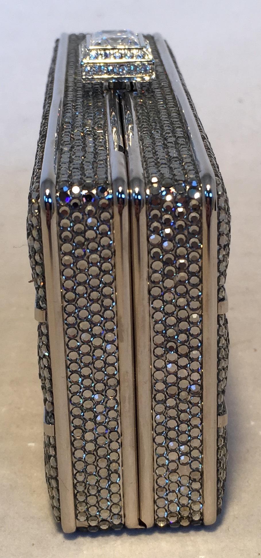 Beautiful Judith Leiber Silver Swarovski Crystal Stripe Minaudiere Evening Bag Clutch in excellent condition. Silver Swarovski Crystal exterior with silver body in a unique triple stripe rectangle shape and pattern. Top Crystal button closure opens