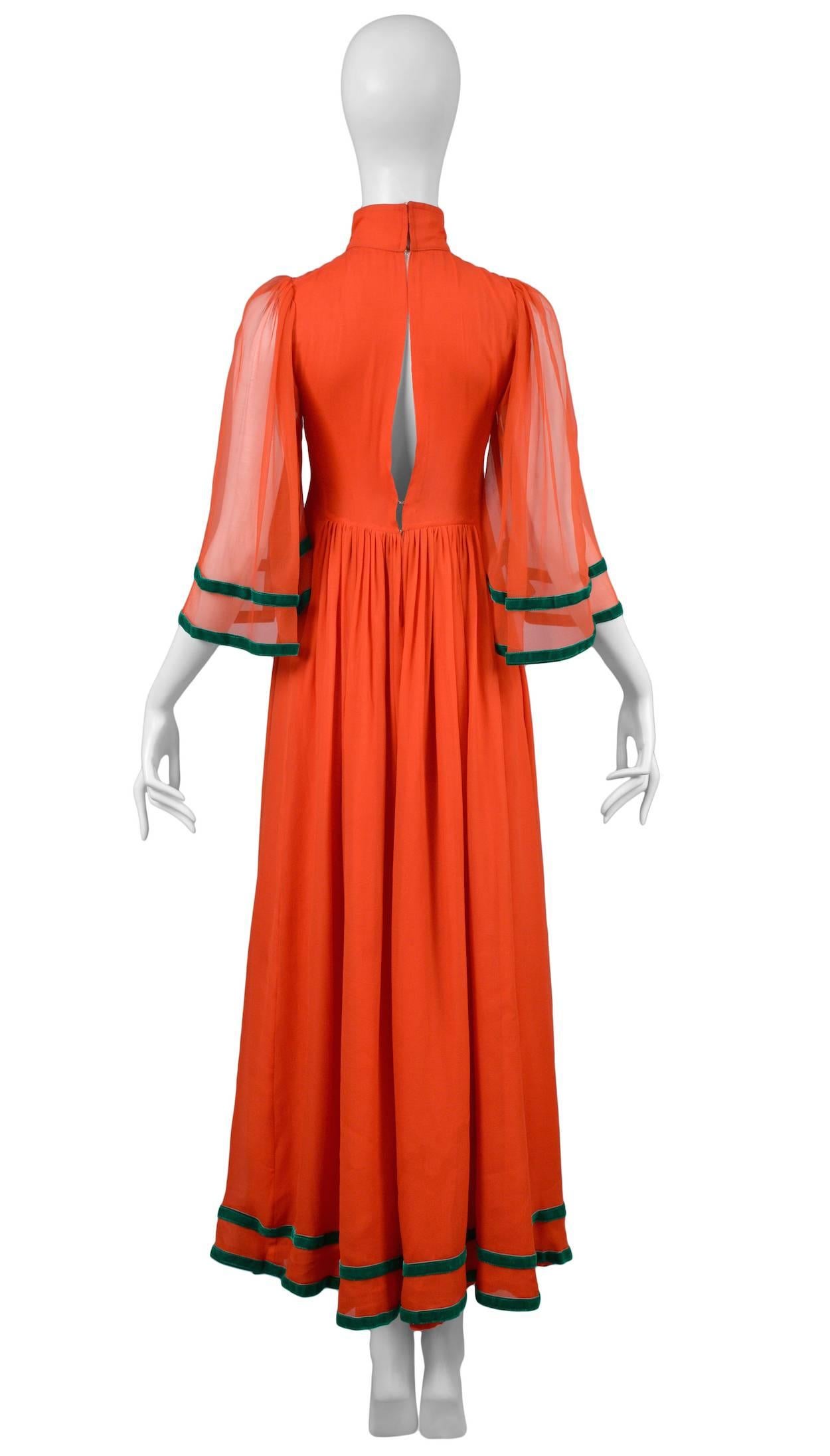 Red chiffon caftan dress with vintage embroidery fabric at bust with mirror insets. Dark green velvet ribbon trim and zip black closure with hook and eye.
Please inquire for additional images.