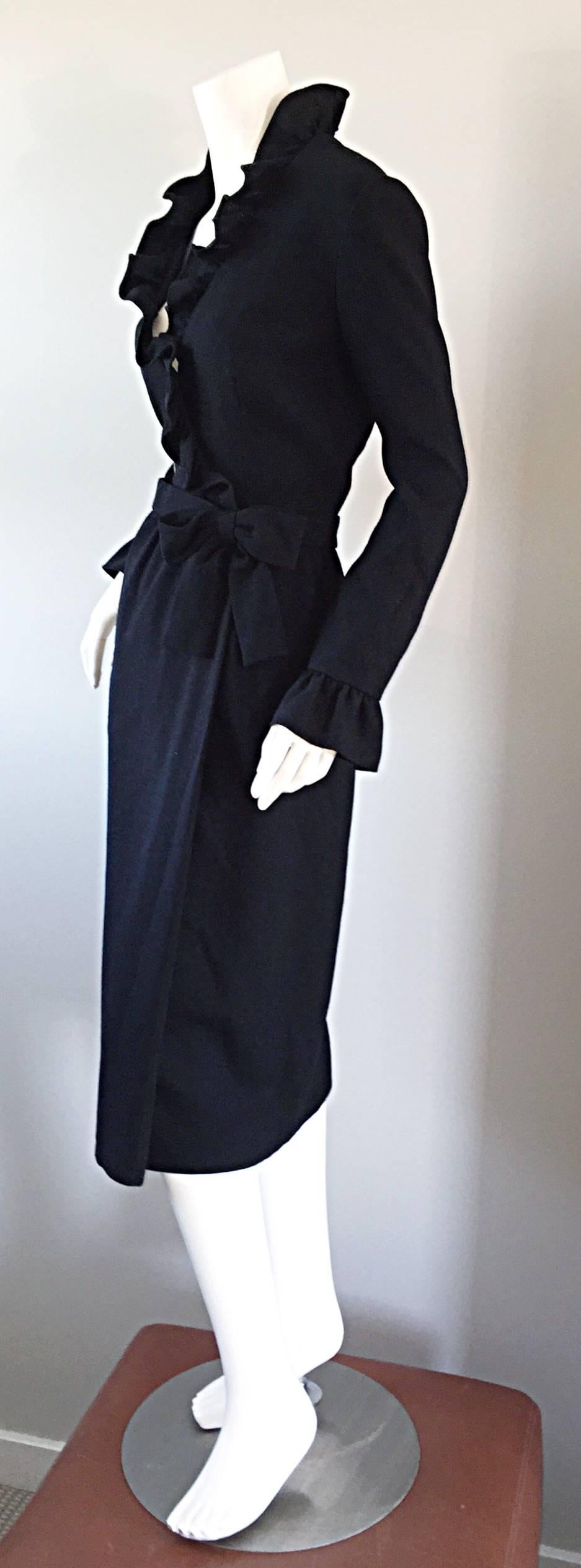 Chic late 1960s Mollie Parnis black wool wrap dress! Flattering fit, with a ruffled neckline, and ruffled bell sleeves. Wrap style, with bow belt detail at side waist. Interior hook-and-eye closure, with full hidden metal zipper in the back. Fully