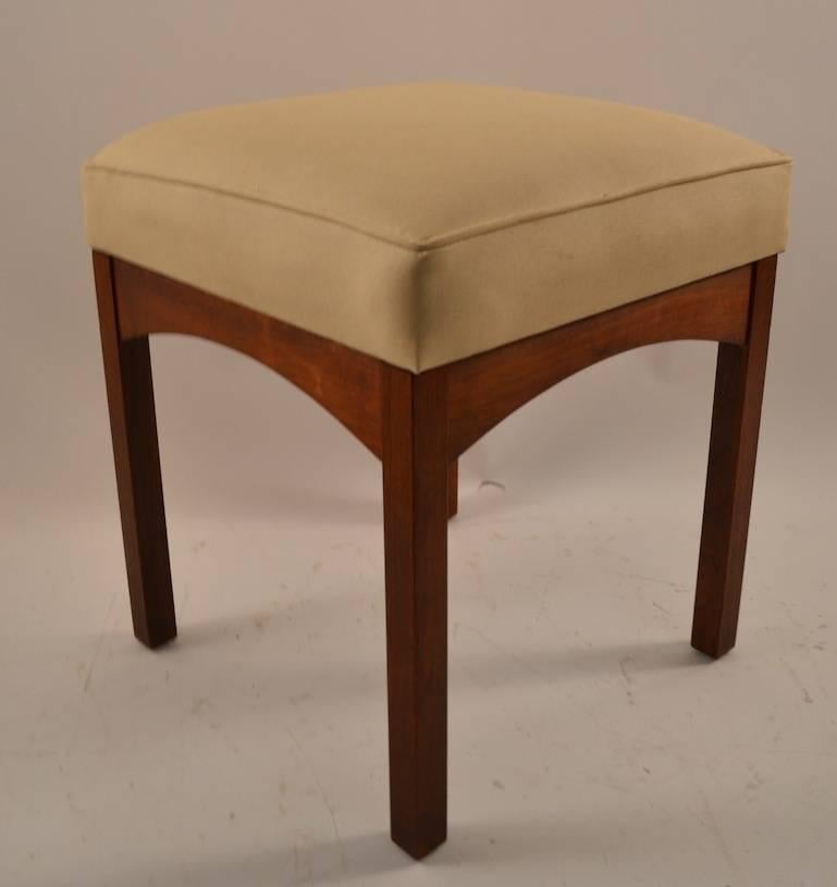 Solid walnut frame, vinyl upholstered top. Available as a pair, or individually. Probably American in the Danish style.