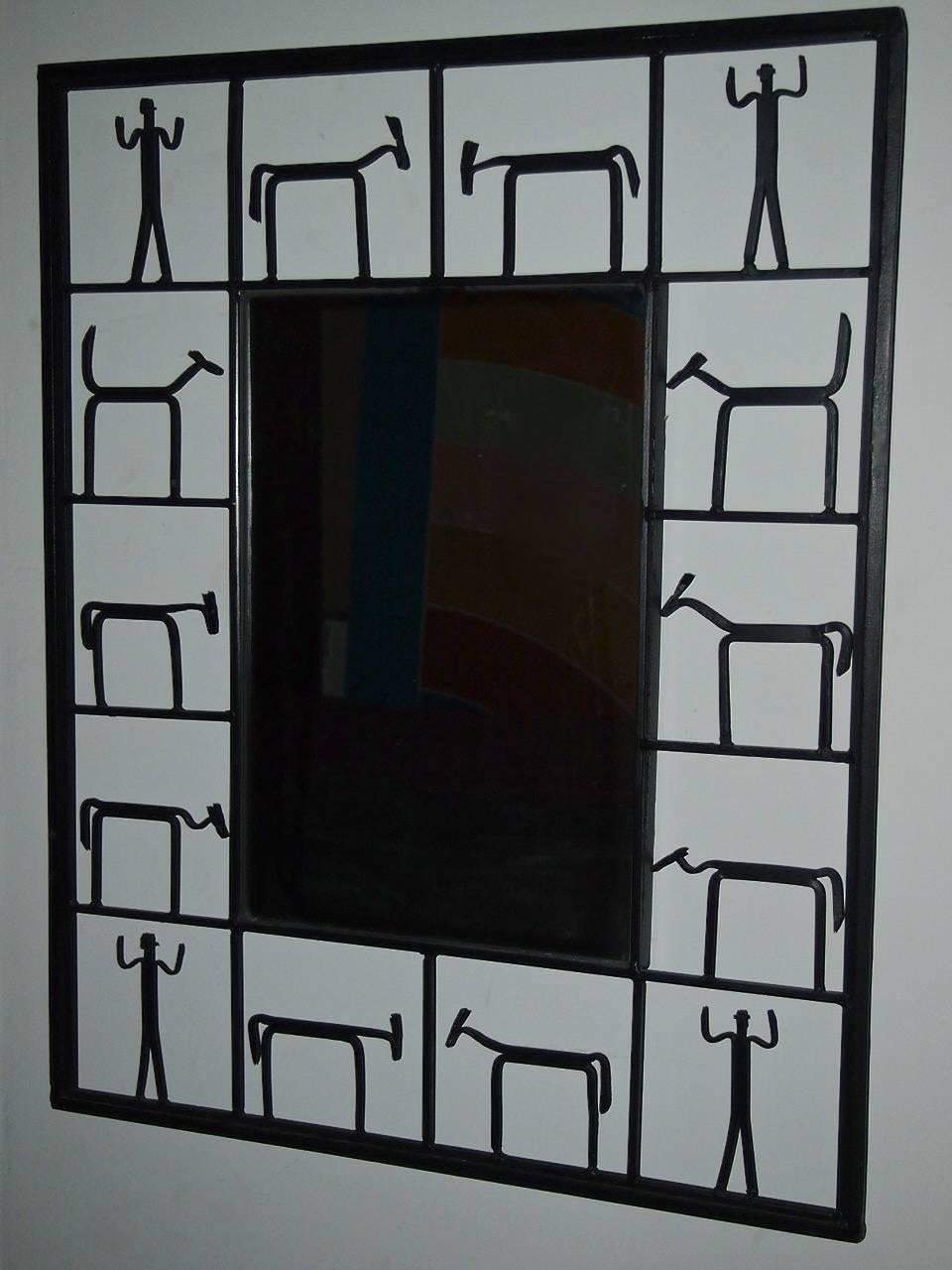 Two matching mirrors each with a black metal frame that supports a rectangular piece of mirrored glass in the center. The frames each have 14 detail figures of both man and animal.