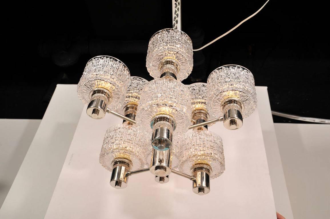 Exceptional nine-arm vertical cut crystal chandelier  with a chrome frame and ceiling cap. Rewired for use in the USA using edison type bulbs,  40W max.