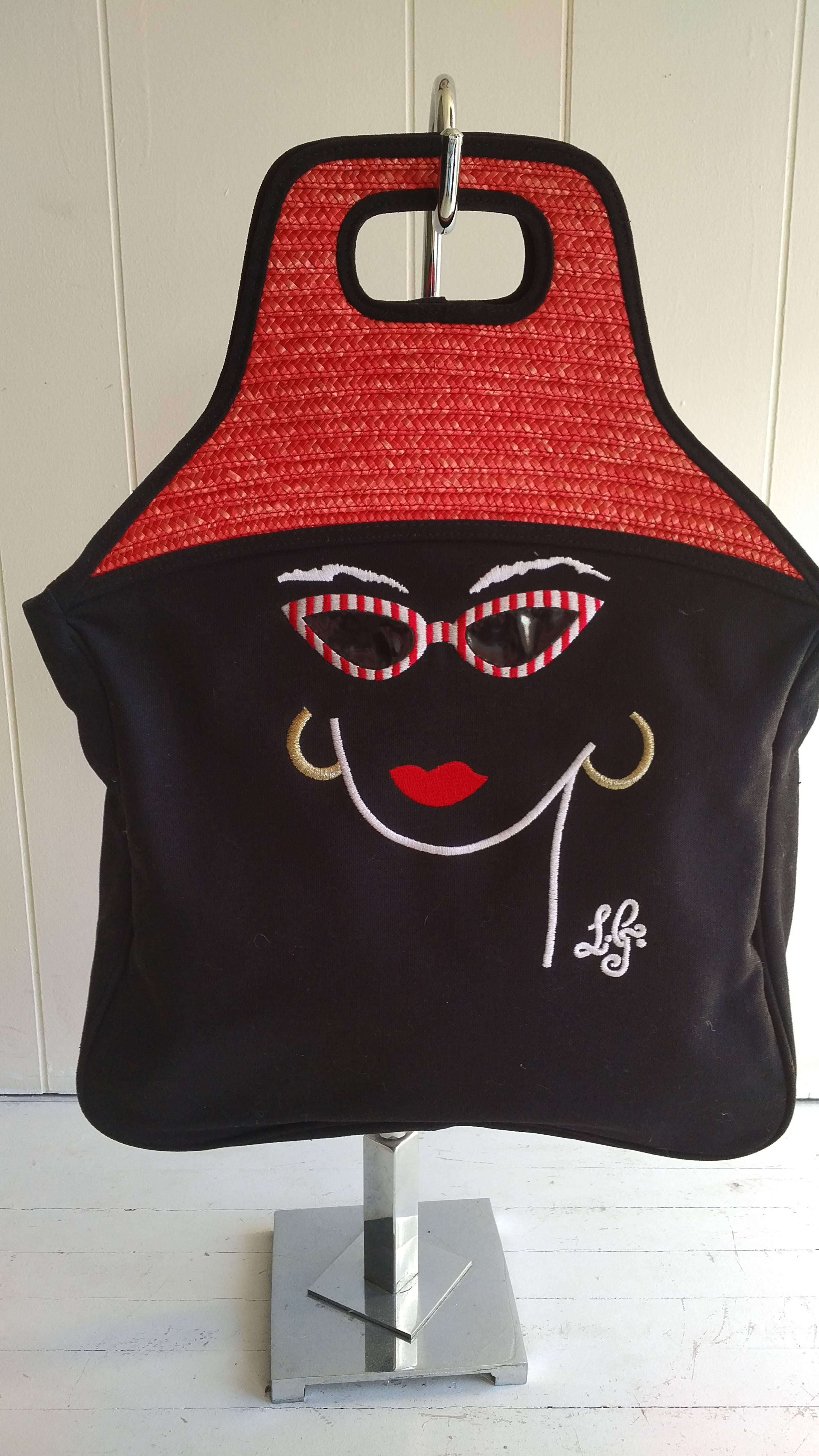 Known for her quirky designs this red straw handled and canvas tote is typical of her work.

Hat shaped handles in straw are followed by an embroidred face wearing striped sunglasses. The inside feature a zipped pocket.

This bag was never used (but