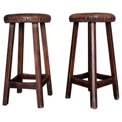 A pair of Swedish 1930-40s workshop stools in solid pine, original leather seats