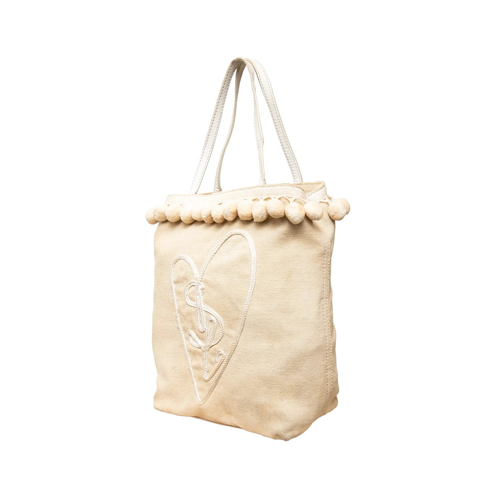 Yves Saint Laurent Rive Gauche Beuteltasche aus beigem Canvas mit Stickereien, Ledergriffen, Bommelakzenten, Satinfutter und offener Oberseite.
 Bemerkungen: Es gibt einige Flecken.  
 Abmessungen: Höhe:28;Breite:19;Tiefe:9;Henkelfall:14 
 MATERIAL: