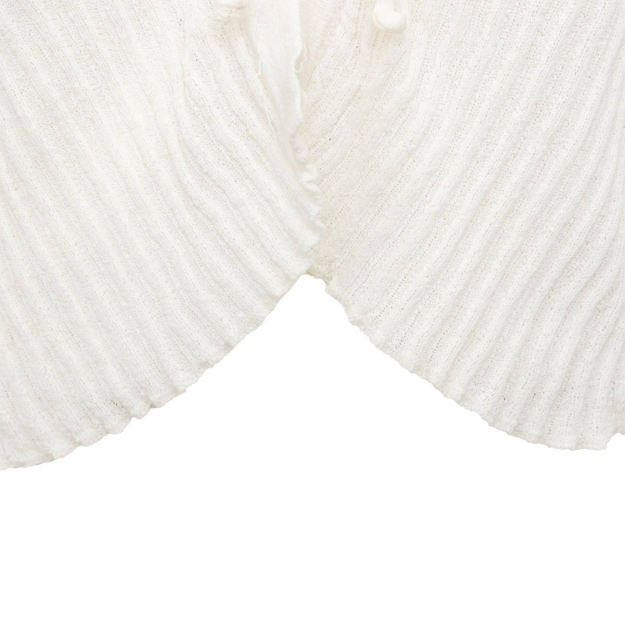 G Gigli cardigan ouvert blanc cassé en maille côtelée. Il est doté de manches longues ajustées et d'une fermeture à nœud de cravate. Une superposition chic pour toutes les saisons.
 Remarques : L'étiquette de composition est décolorée.  
 Mesures :