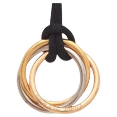 Cartier “Trinity” 3 colour gold pendant with black silk cord