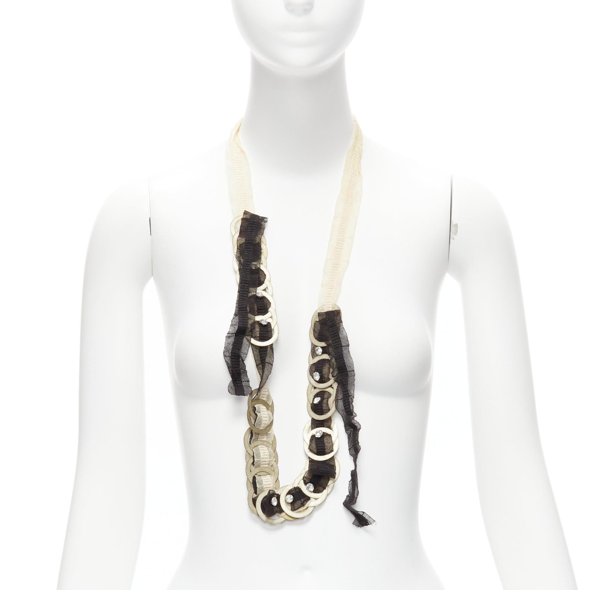 CHAMOREL collana lunga in maglia nera nuda con nastro in oro antico e moneta in cristallo in vendita