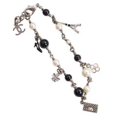 Chanel-Armband aus silberfarbenen Perlen mit schwarzen Kunstperlen und verschiedenen Anhängern, 2013