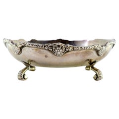 Silver bonbonette box w/ raised friezes & 3-flower knob on 3 palm feet
