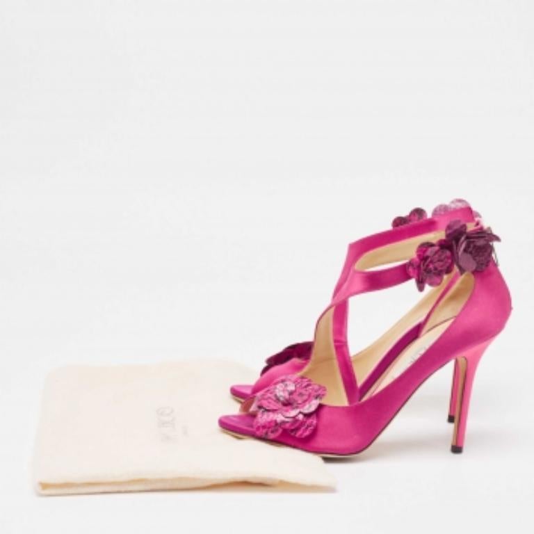 Embodying a pleasing pink shade, these sandals are the perfect choice for cocktail parties. Made from satin along with python leather and flaunts flowers on the vamps and ankle straps. Featuring rear zipper closures, the insoles are leather lined.