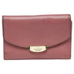 Cartera compacta tríptico de piel rosa Kate Spade