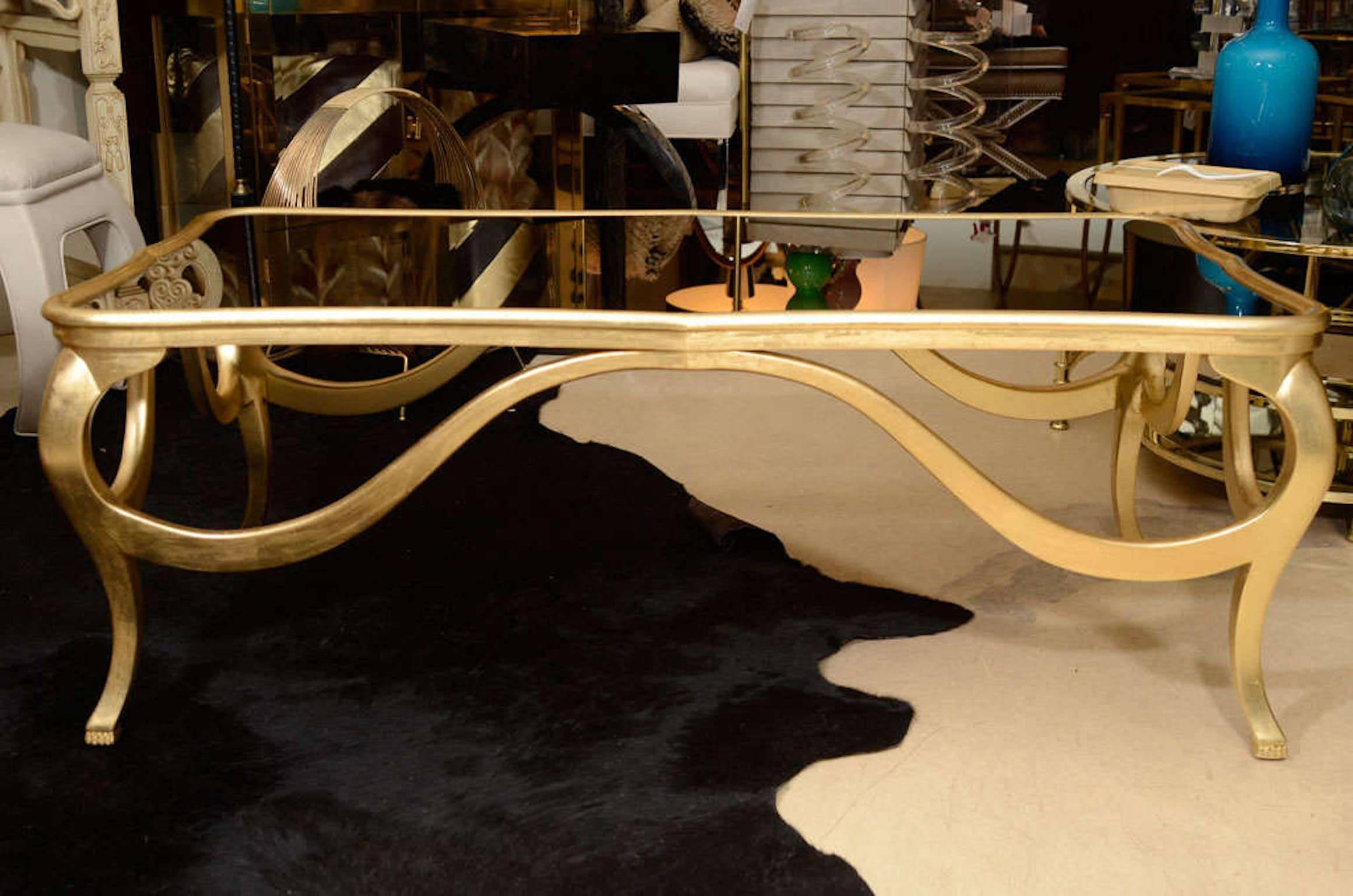 Decorative coffee table. Gold leaf finish with a mirror top, C 1940.