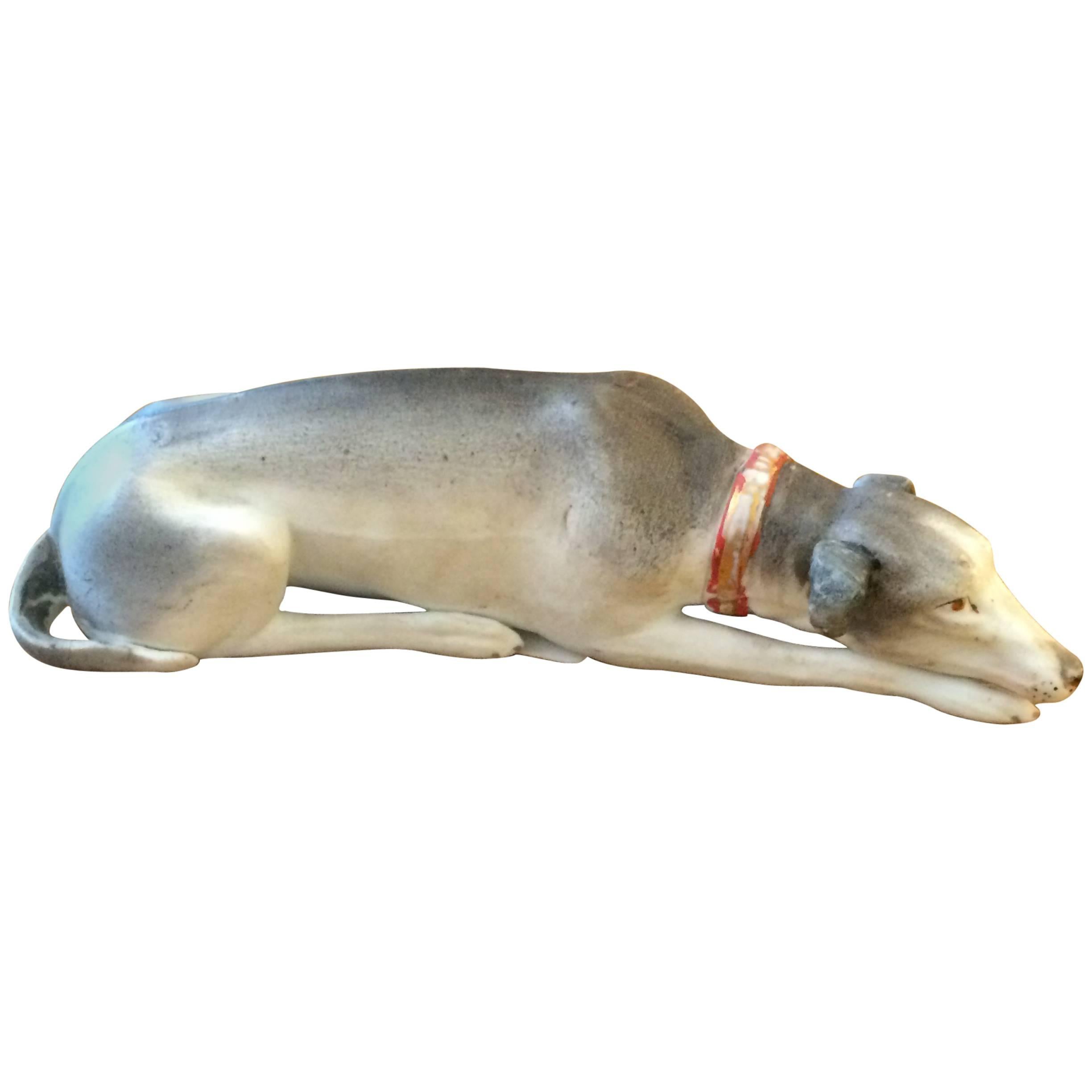 Wonderful pair of vintage Staffordshire having reclining hunting dogs and rabbits, beautiful gold leaf decoration on the edges.

Lovely small elegant sculpture of a grey and white reclining greyhound dog.
