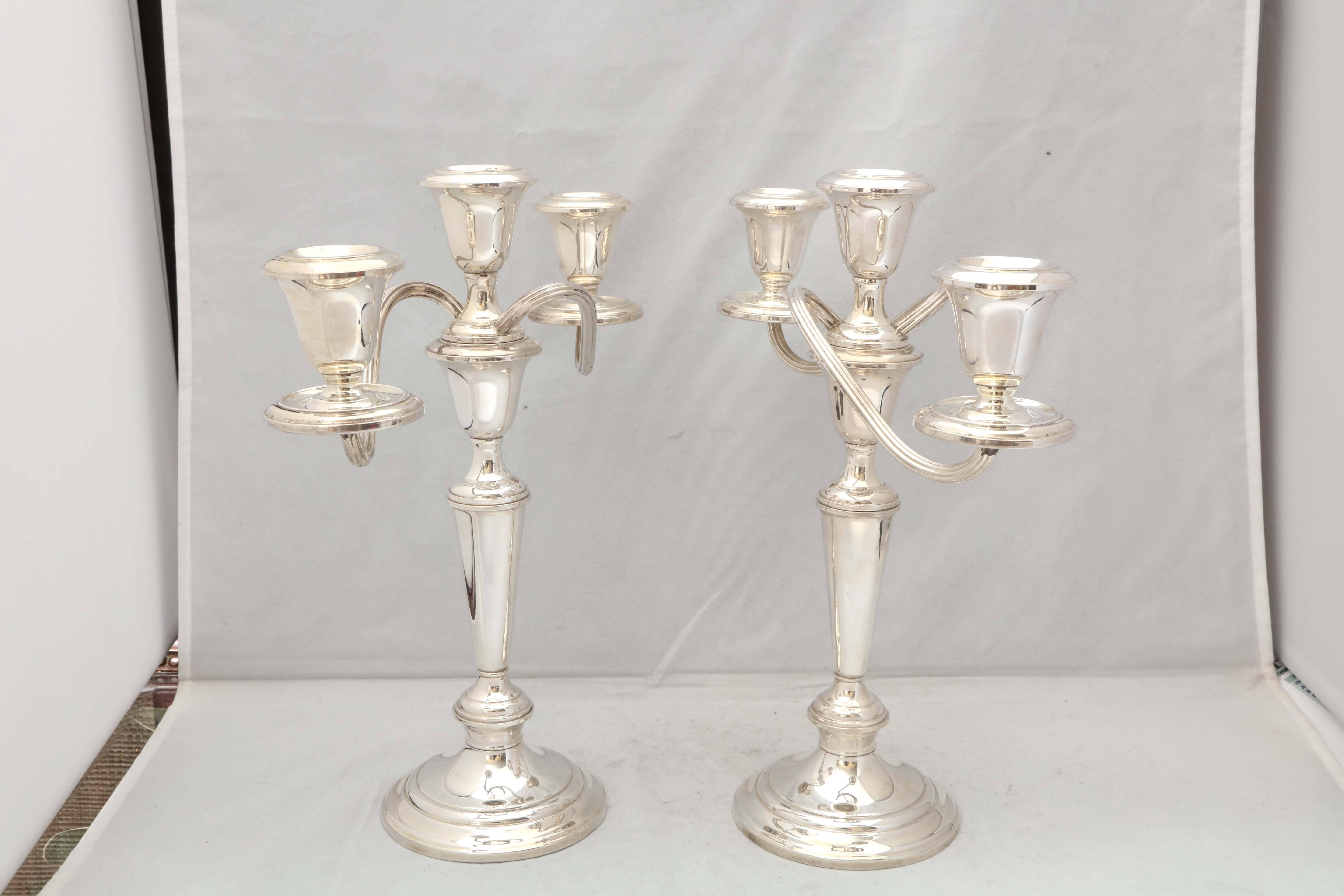 Pair of Empire style, sterling silver candelabra, The Gorham Manufacturing Co., Providence, Rhode Island, circa 1930s. Each candelabrum separates into three parts to form three different sizes of candlesticks. The 